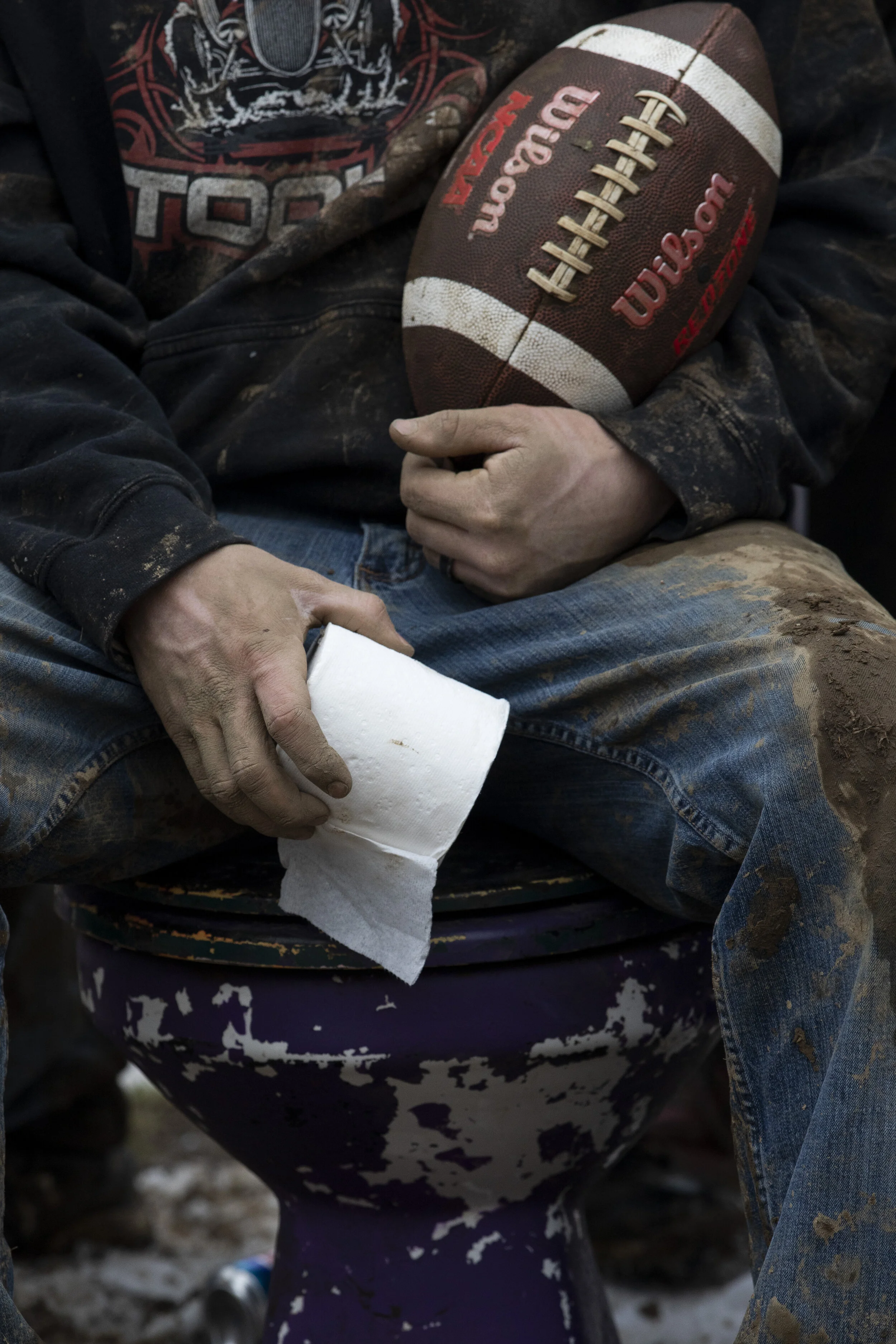  Kody Cummings sits on his purple toilet trophy after being voted the most valuable player for the Toilet Bowl on Sunday, February 14, 2021. For over forty years, New Marshfield residents have held a pick-up football game the Sunday after the Super B