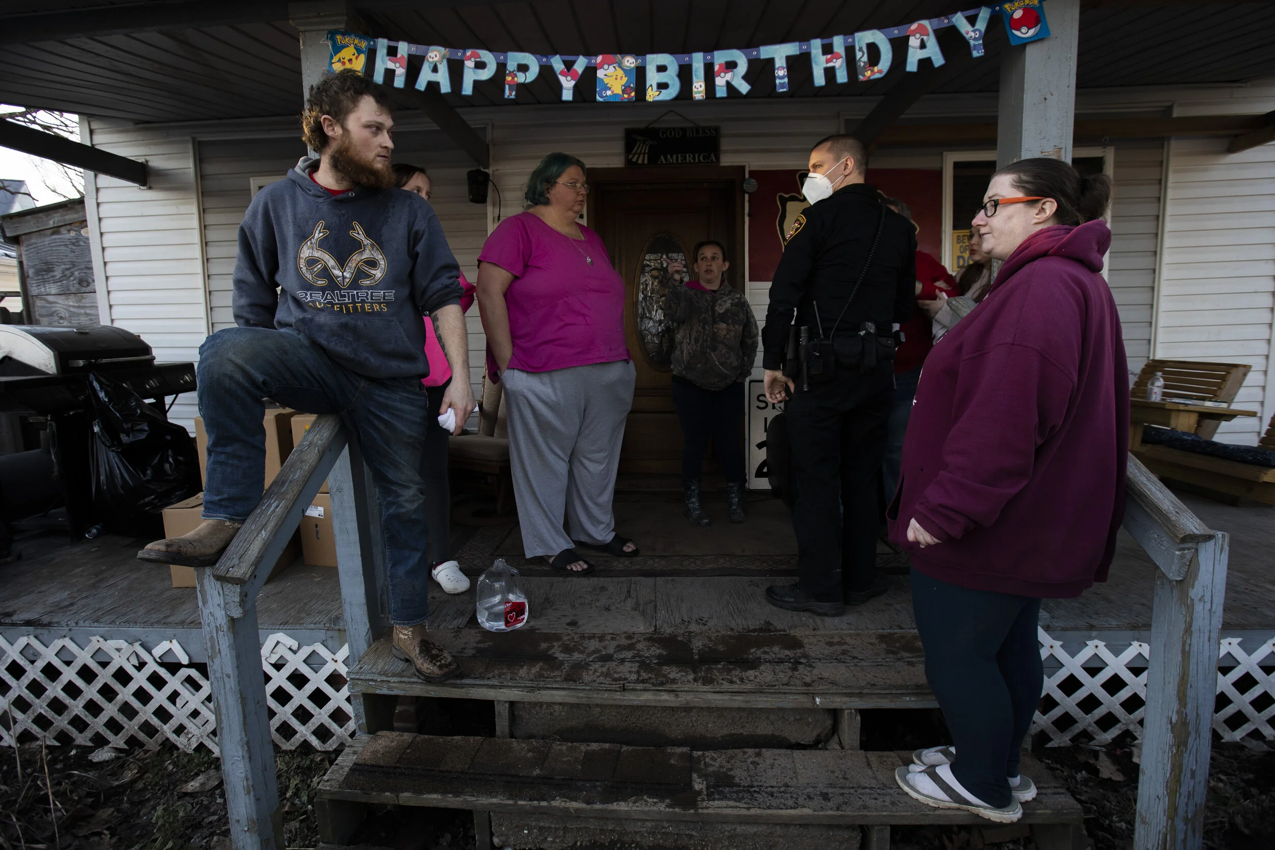  An Athens County Sheriff's deputy speaks to attendees of a birthday party in New Marshfield after Kody Cummings, left, and three others were pepper sprayed by a neighbor on Saturday, February 6, 2021. Tina Osborne and her daughter Danielle Osborne c