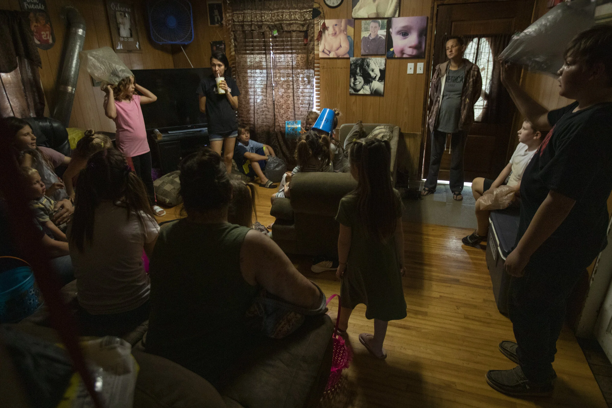  More than 20 children from New Marshfield gather in the Osborne home while parents and other family members hide Easter eggs around the main square at the center of town on Saturday, April 10, 2021. Tina Osborne and other community members decided t