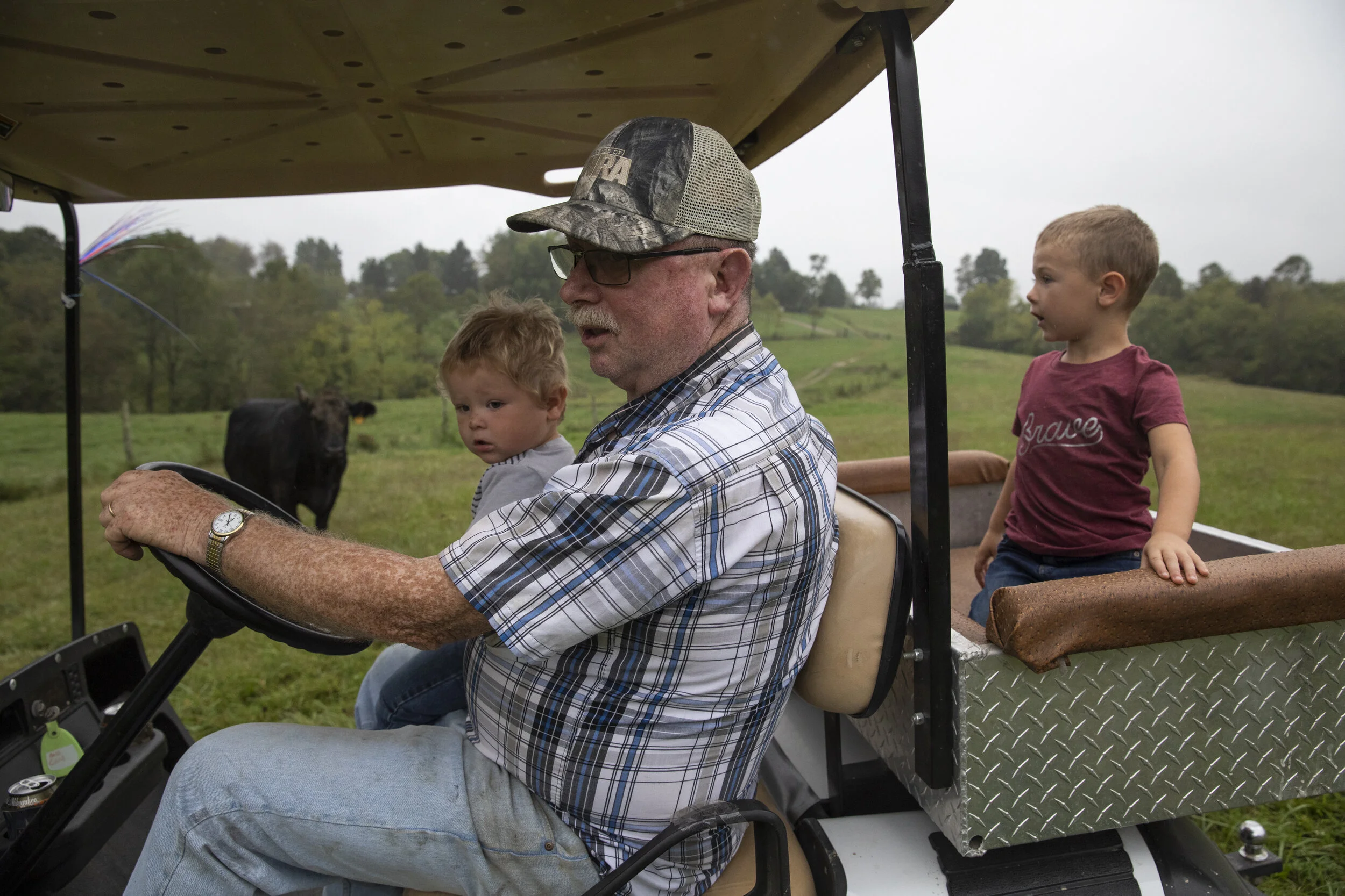  Chris McLaughlin takes Mangus and Silas Shaulis down to visit his cows on Sept. 21, 2021. On Thursdays and Fridays, Chris and Danita’s two older grandchildren get off the school bus at their home before their dad comes to pick them up. 