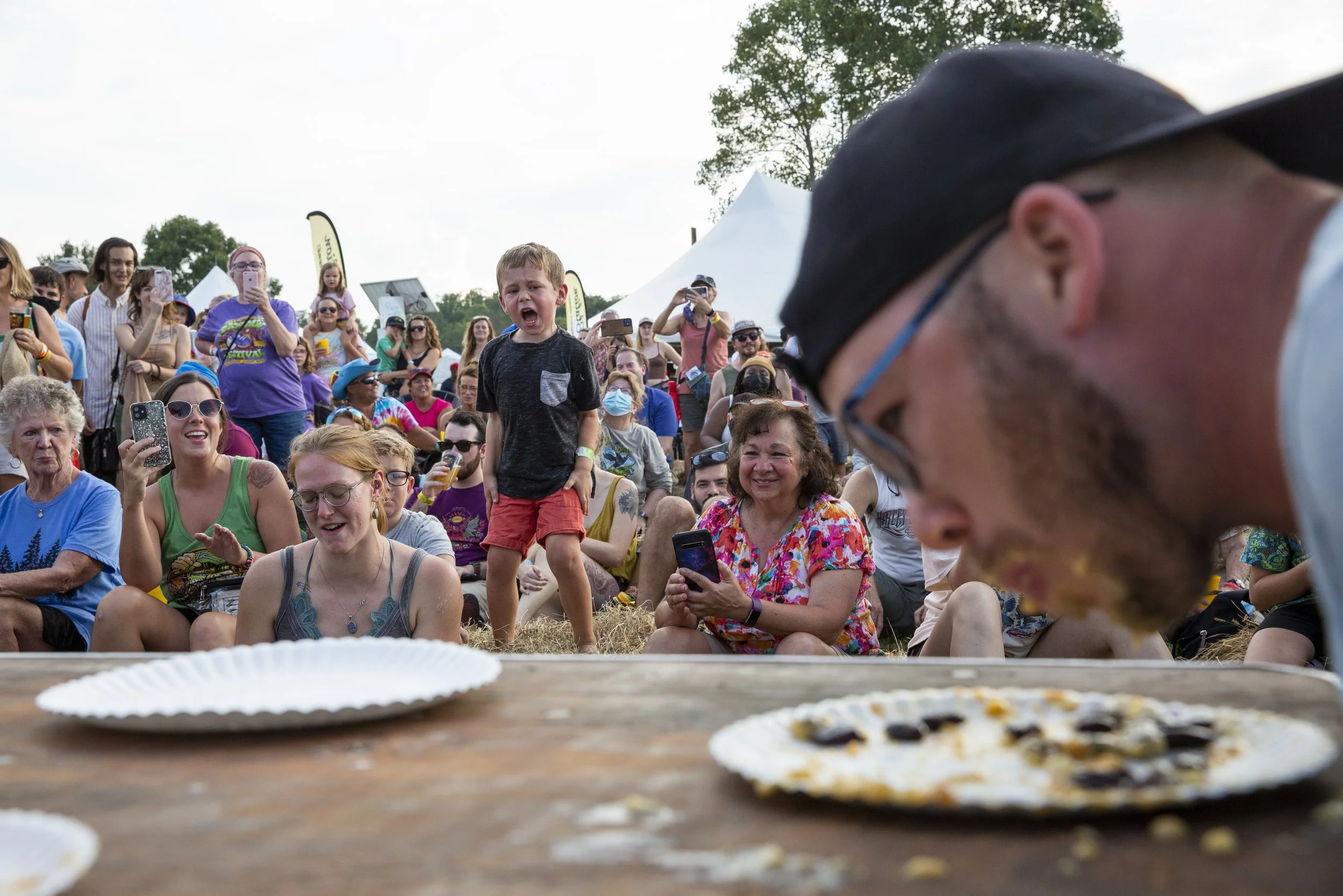  Ryan Gartley competes in a pawpaw eating contest as attendees watch and cheer during the 23rd Annual Ohio Pawpaw Festival in Albany, Ohio, on Saturday, September 18, 2021. Gartley, who ultimately won the competition, said this is his second pawpaw c