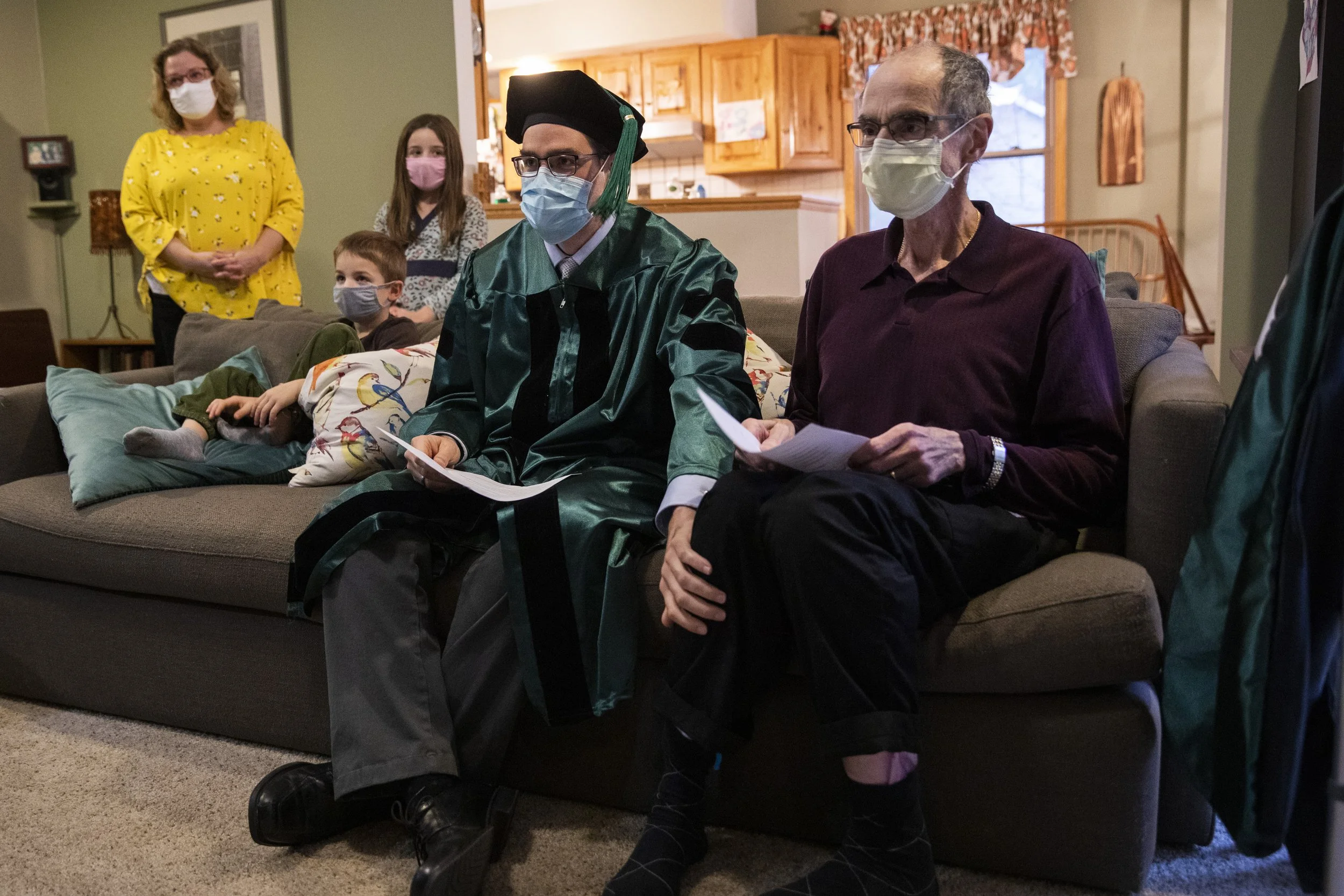  Michael Soroka touches his father Dr. Mike Soroka's leg as they listen to a commencement address by the dean of Ohio University's Heritage College of Osteopathic Medicine on October 28, 2021. Mike Soroka was terminally ill with cancer. When it seeme