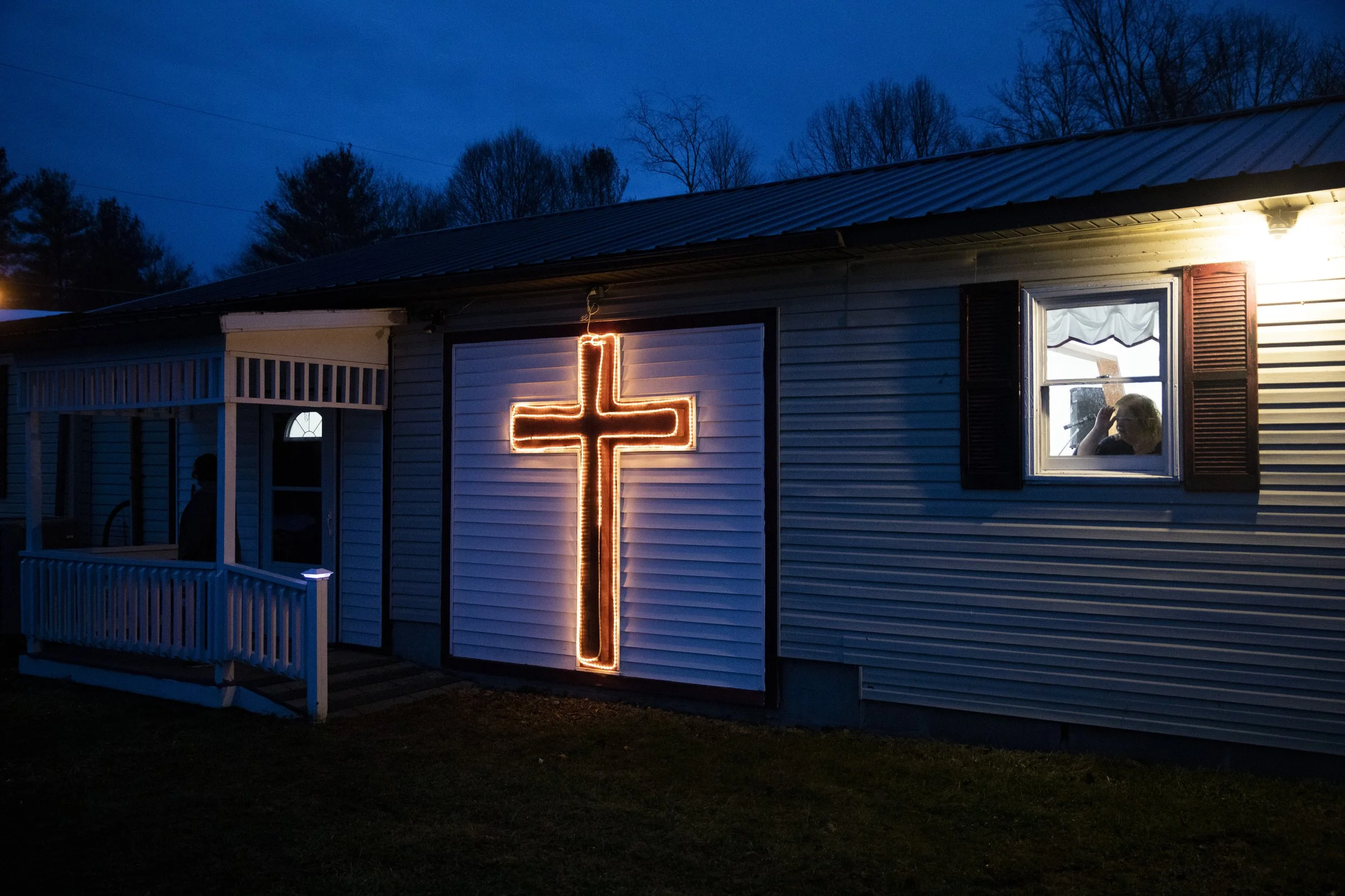  Diana Burns looks out the window of the House of Prayer church to see if anyone else is coming to the service in Glouster, Ohio. Four people attended the Wednesday service and the pastor couldn’t make it because of worry over a storm that was foreca