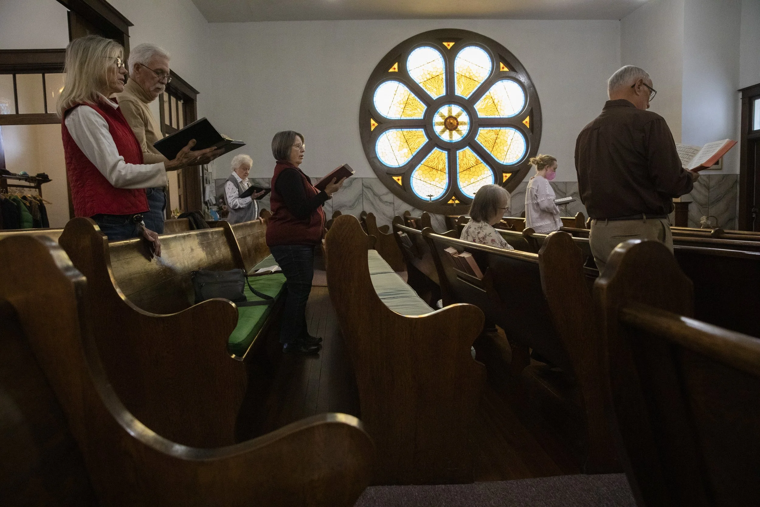  The congregation at Stewart Methodist Church in Stewart, Ohio, stand up to sing a hymn during the Sunday morning service. Eleven people attended the service. The group believed that some of the normal attendees had stayed home due to snowfall the ni