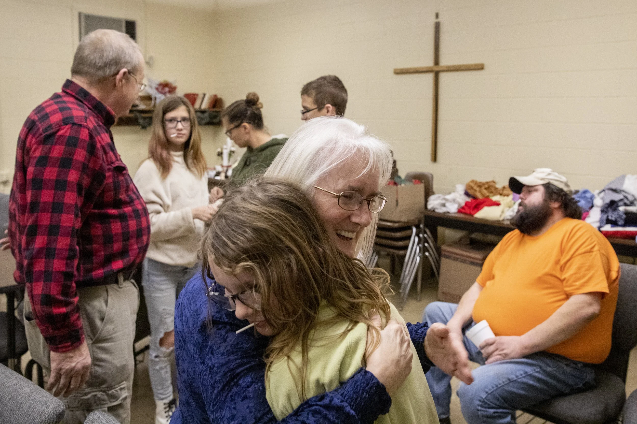  Leona Winegardner hugs Shayla Taylor, 10, at Faith Baptist Church in New Marshfield, Ohio. While her husband, Adelbert Winegardner, left, holds the Bible study session for adults, Leona and a parent from the group play games upstairs with the kids i