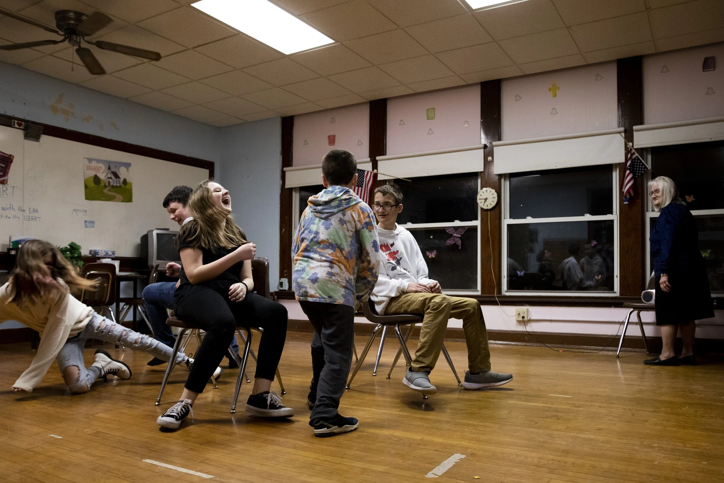  December Johnson, 11, falls out of her chair after Gage Taylor, 12, pushed her to get it when the music stopped during musical chairs with Ashlee Lowry, 11, Joshua Parks, 11 and Justin Johnson, 13, at Faith Baptist Church in New Marshfield, Ohio. Le