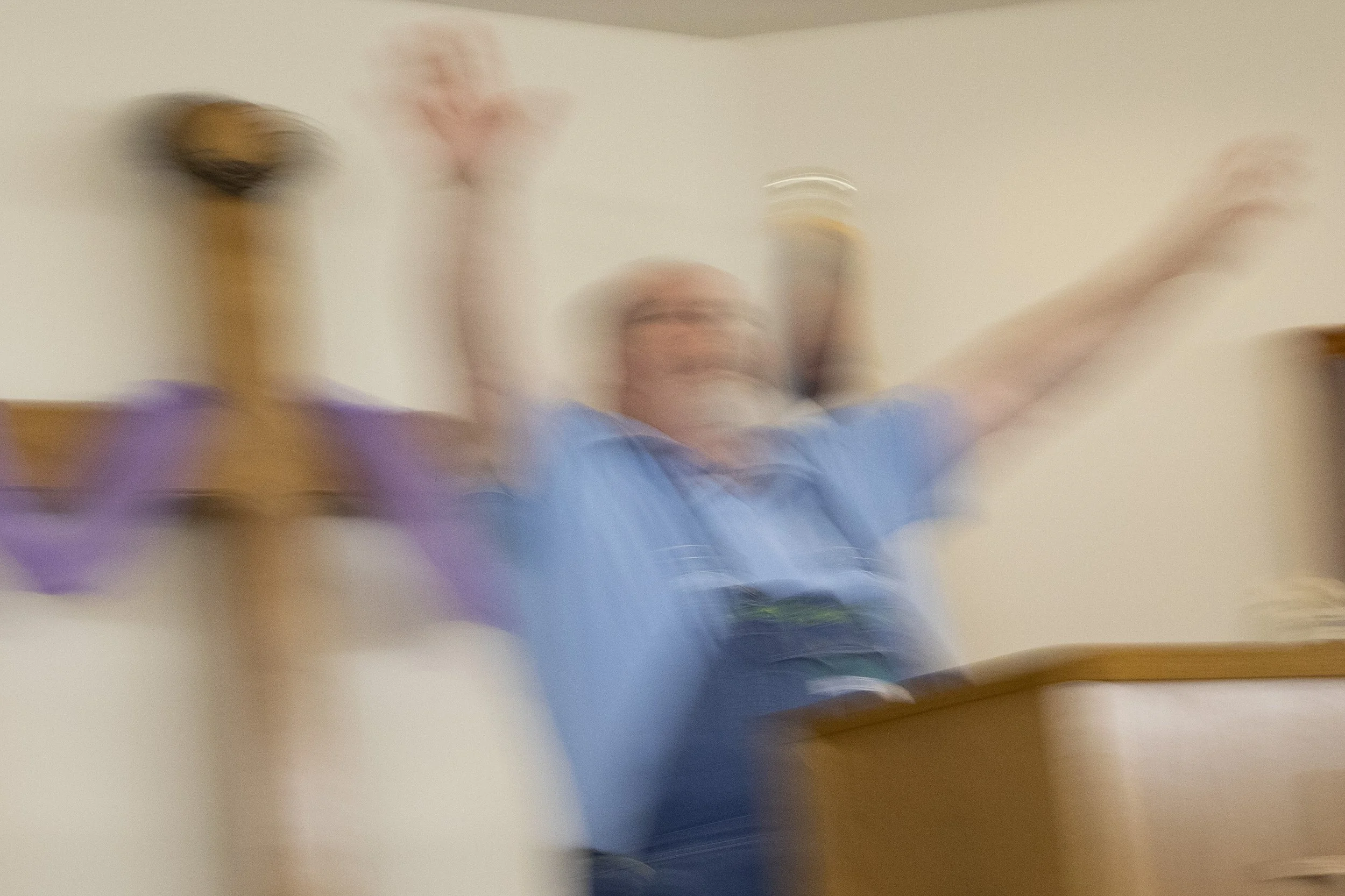  Pastor Rob Clark raises his hand in worship while singing a hymn during a Wednesday evening service at In Time Faith Believers at the Church on the Hill in Albany, Ohio. 
