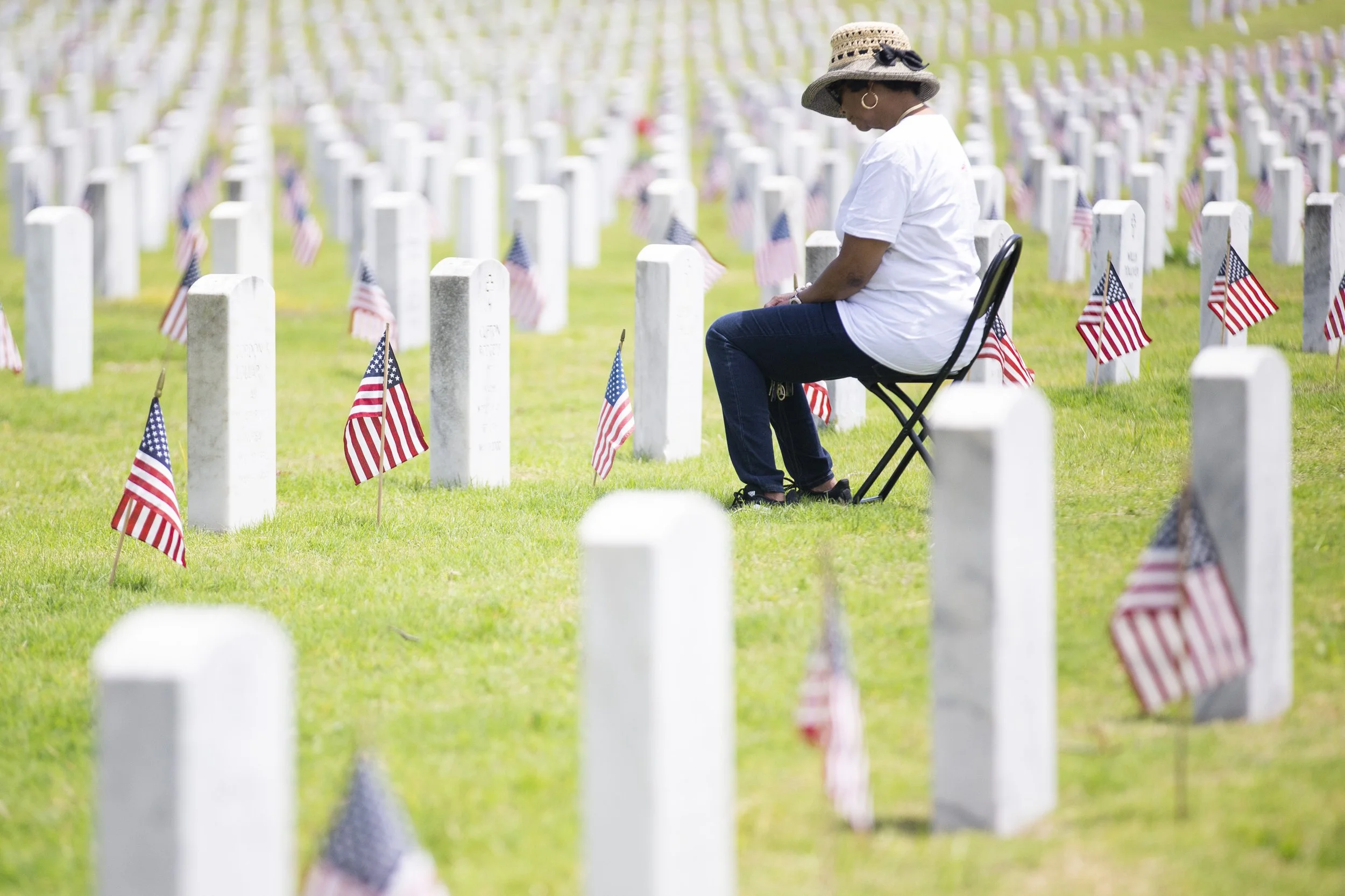  Yvetta Goodman sits and looks down at her grandfather’s grave after the 2023 Memorial Day Ceremony at the West Tennessee State Veterans Cemetery in Memphis, Tenn., on Monday, May 29, 2023. Goodman’s grandmother is buried on the other side and she sa