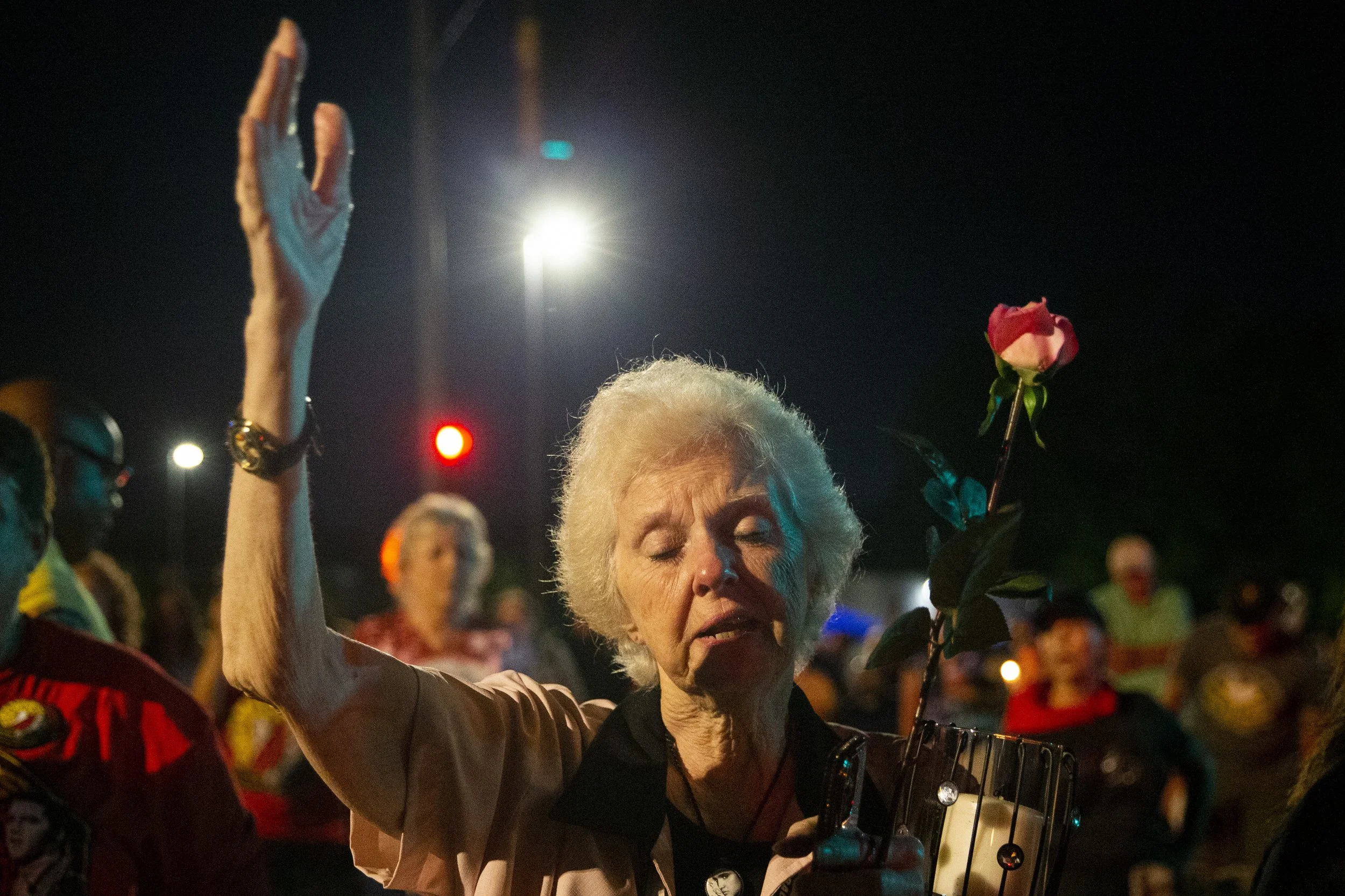  Jerry Engelby, from Jefferson City, Missouri, holds a rose and a candle as she sings along to “Can’t Help Falling in Love” in front of Graceland during the “Candlelight Vigil” as part of Elvis Week 2023 in Memphis, Tenn., on Tuesday, August 15, 2023