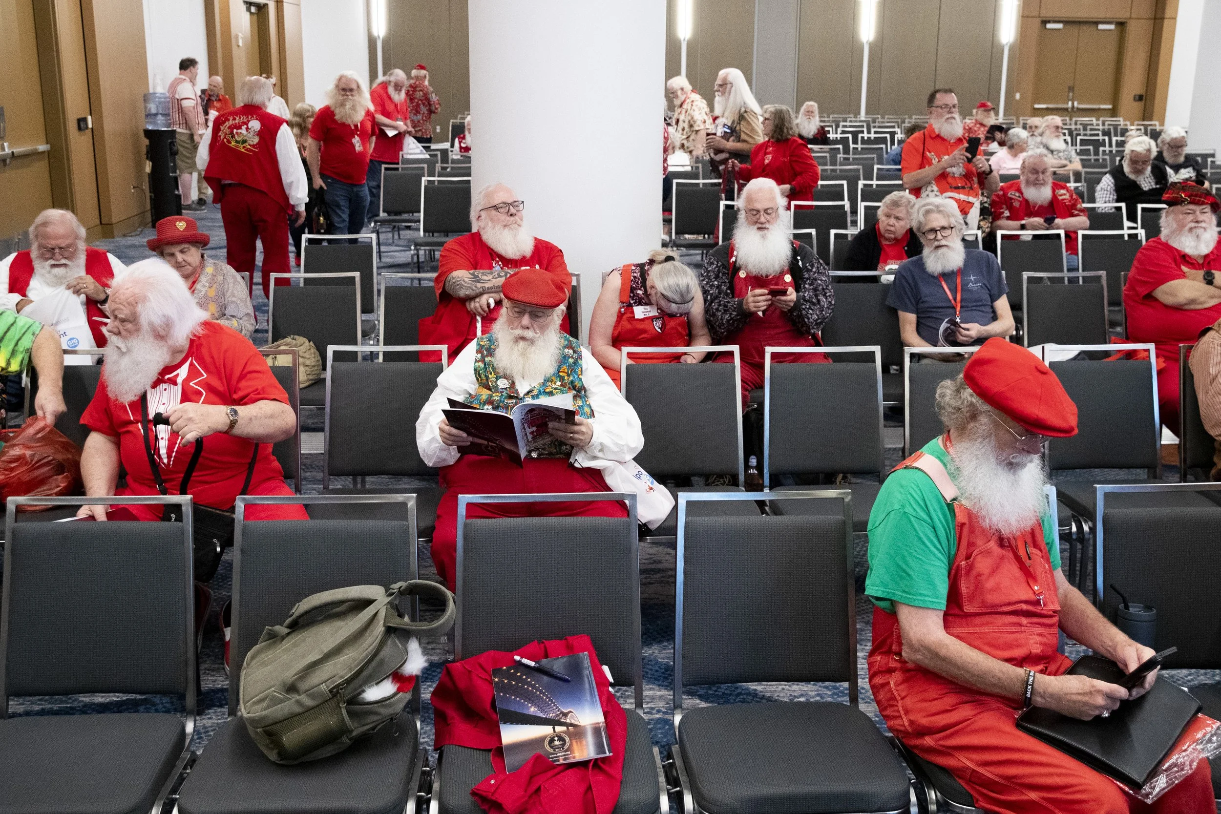  Santas wait for the next workshop to begin during the 2024 International Santa Celebration in Downtown Memphis on Friday, April 26, 2024. The event brings professionals working as Santa or Mrs. Claus together to learn, network and socialize.  