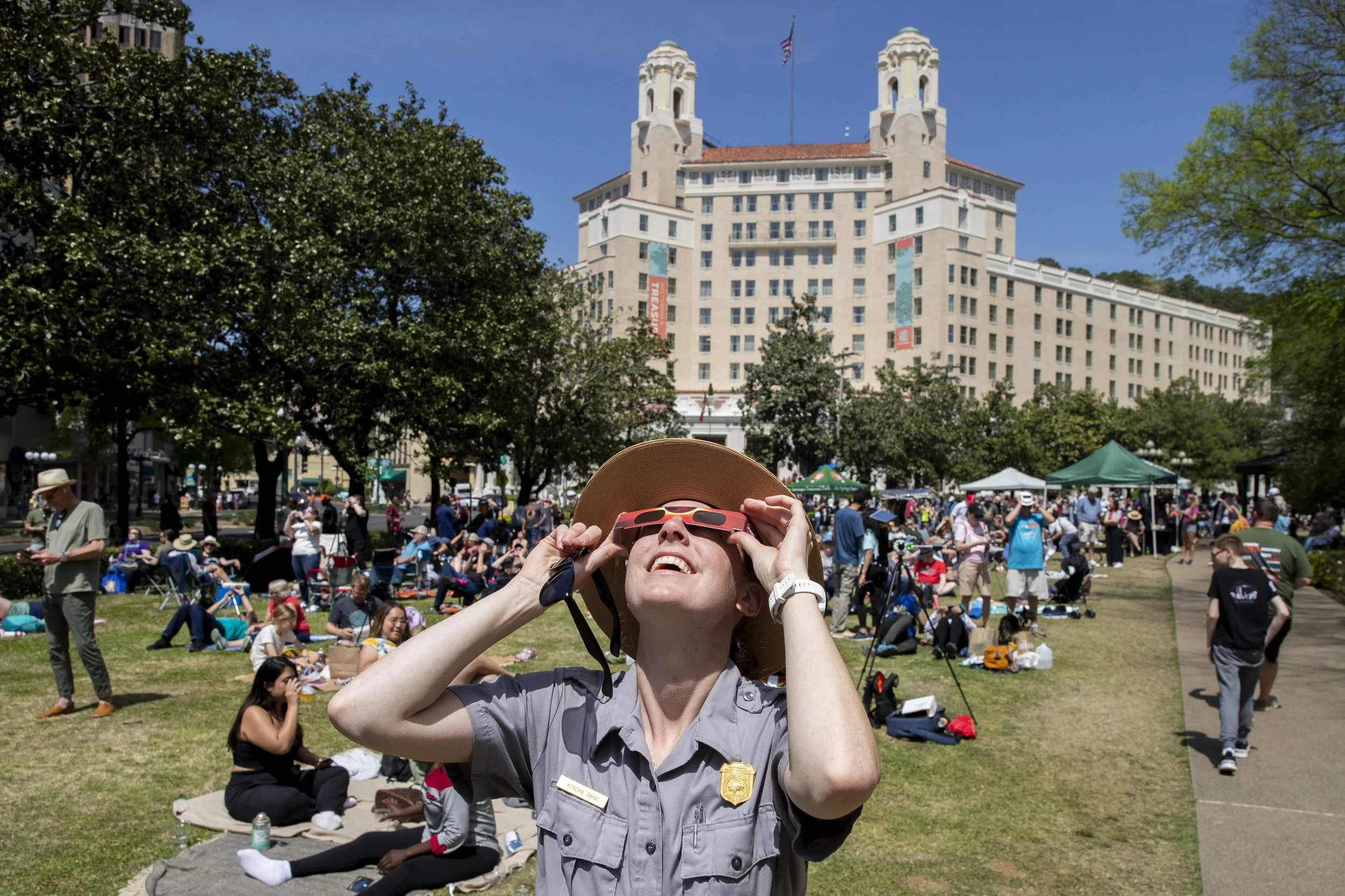  Kendra Barat, a park ranger with the National Park Service, looks up at the solar eclipse on the Arlington Lawn at Hot Springs National Park in Hot Springs, Arkansas on Monday, April 8, 2024. Barat said she is most looking forward to the sense of co
