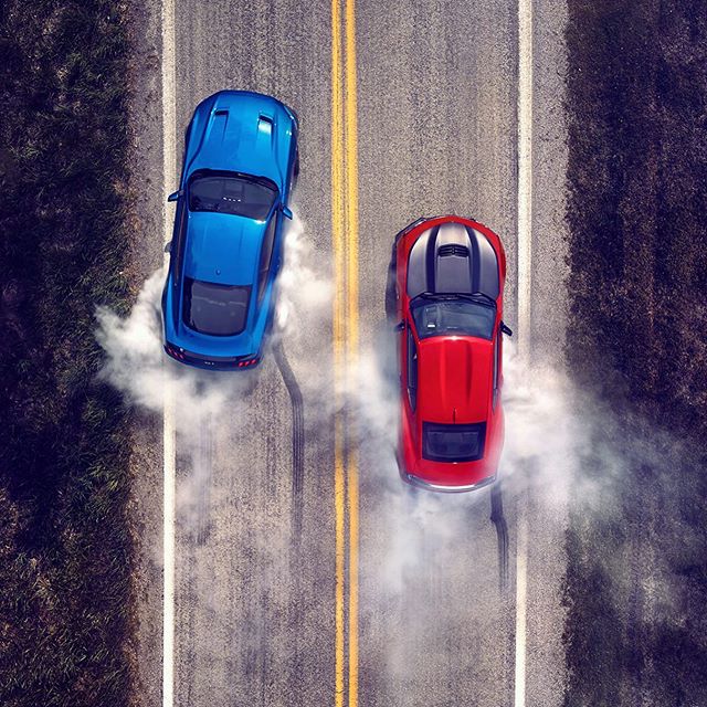 Cover image for @caranddriver. It was a slow drag race.. #burnout #camarovsmustang #mustang #dji #carphotography #dragrace