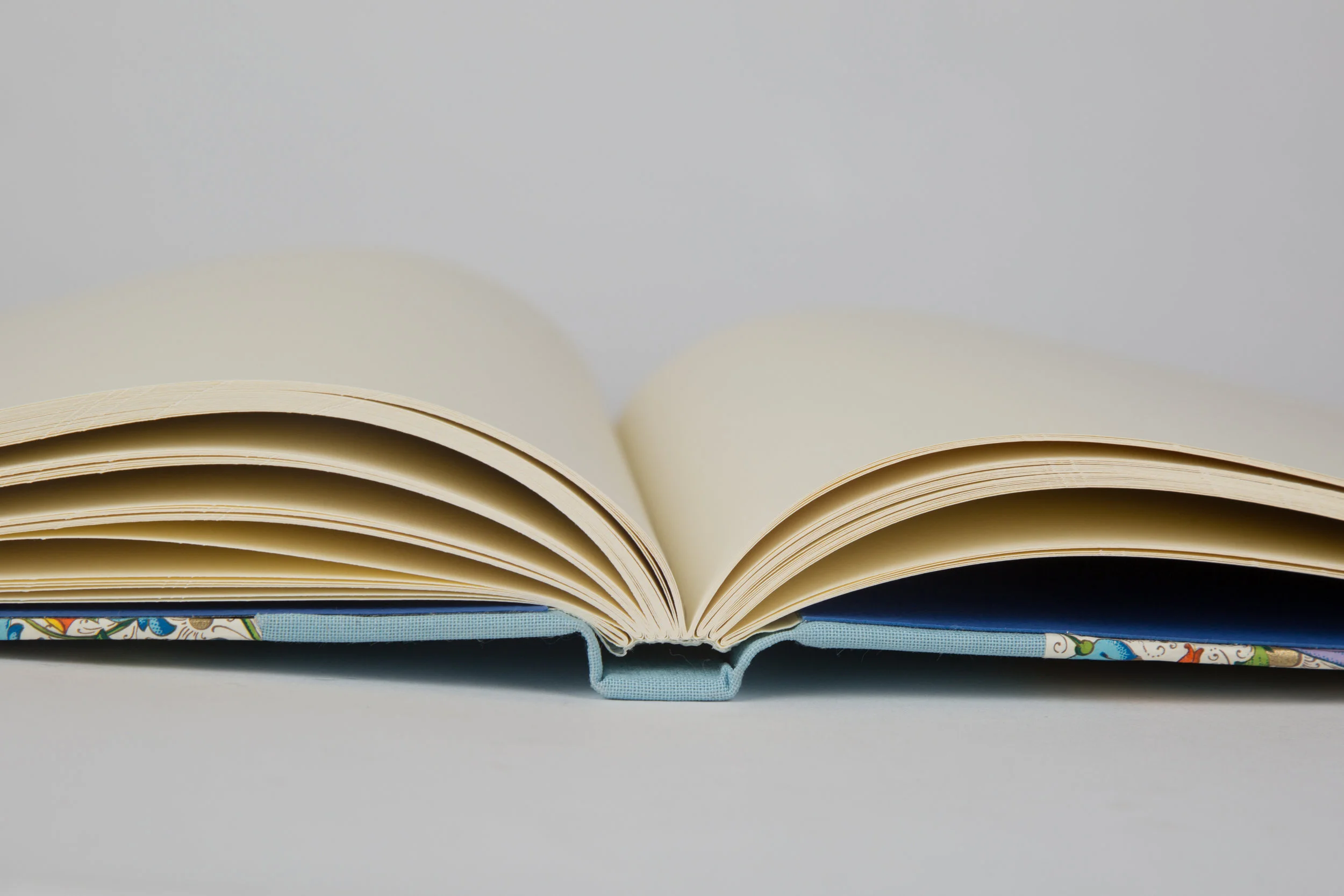Guestbook. Royal blue dublures. Cloth and Italian decorative paper covers.