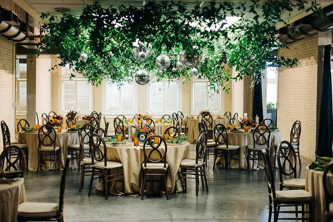 Suspended beneath a canopy of mirrored light and cascading greenery, the room seemed to breathe alive with reflection, movement, and warmth.

For Jamie and Nick, the ceiling design became the heart of the celebration a statement that transformed the 