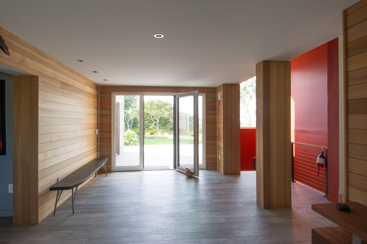 Interior hallway with wood paneling and bench