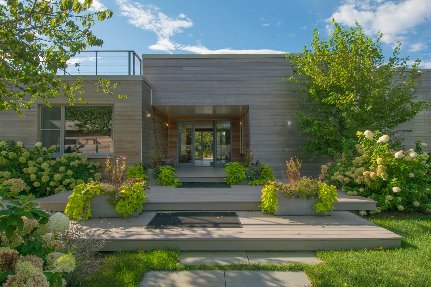 Patios and planters leading up to front entrance.