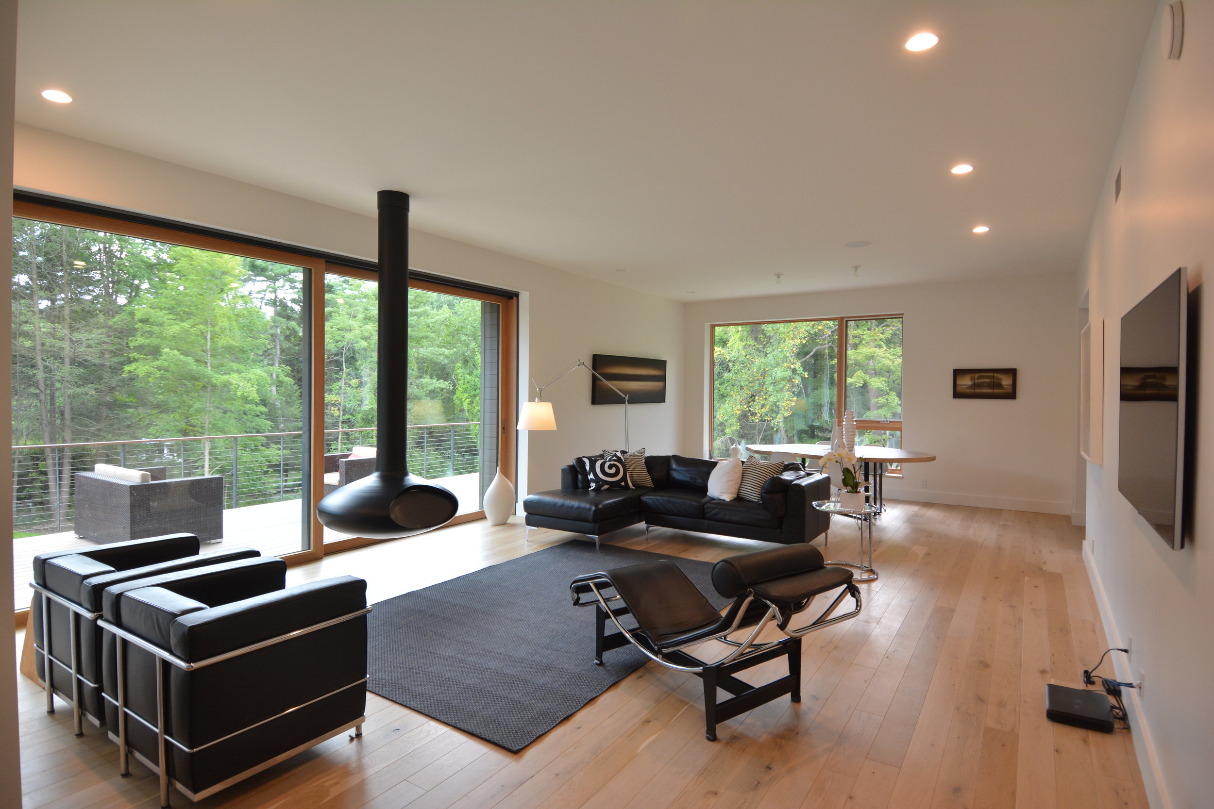 Living room with large sliding doors and suspended fireplace