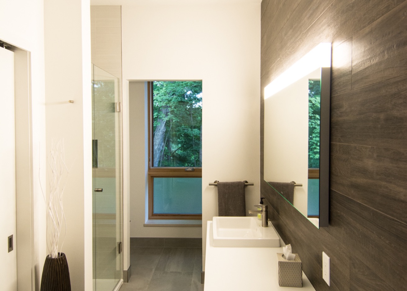 Modern bathroom with lighted medicine cabinet