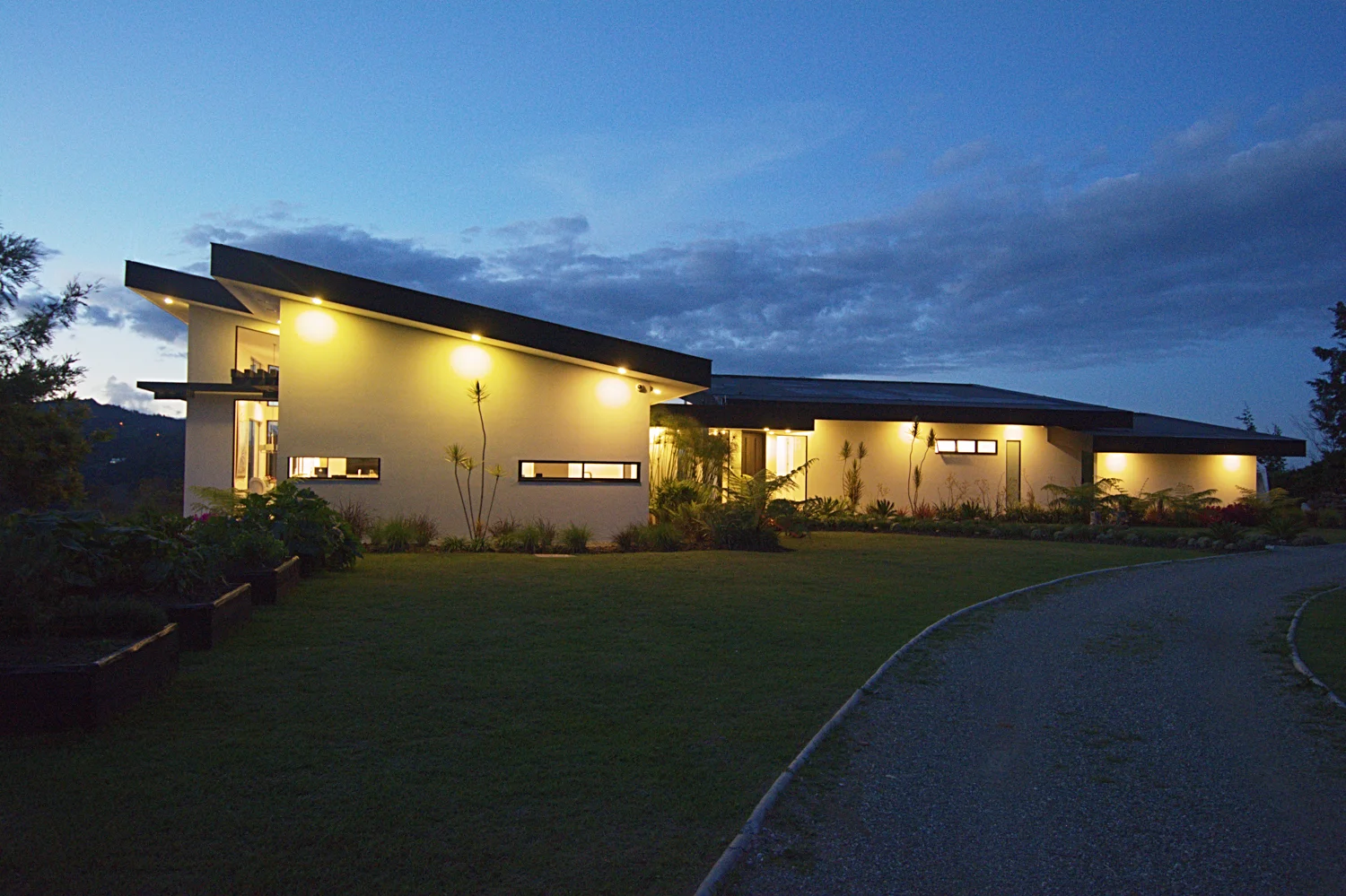 View of house at night from driveway.