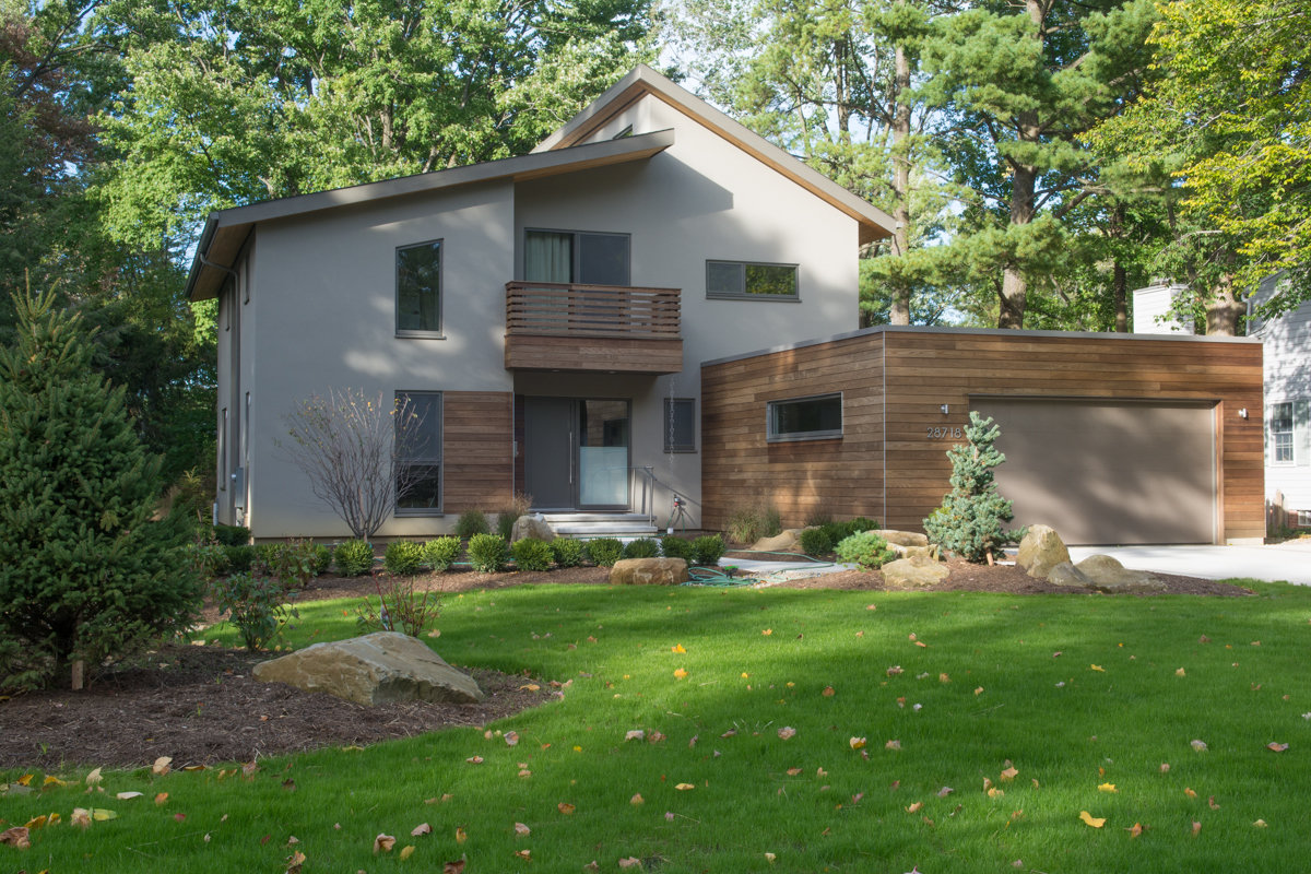 Exterior view of home with lawn and rock garden