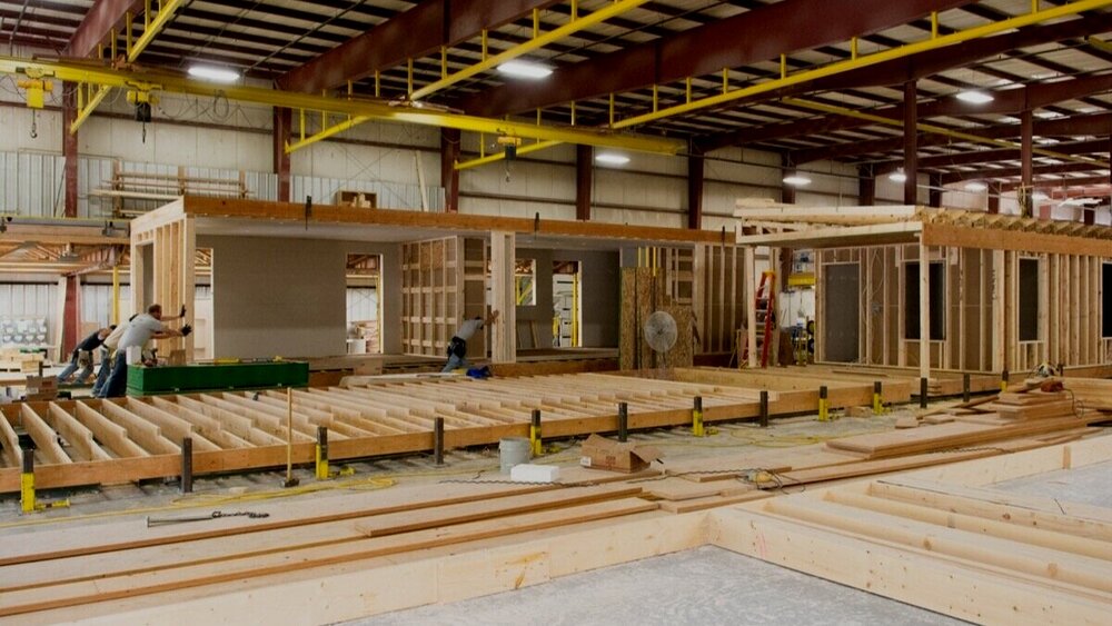 A prefab home being built in a factory setting. 