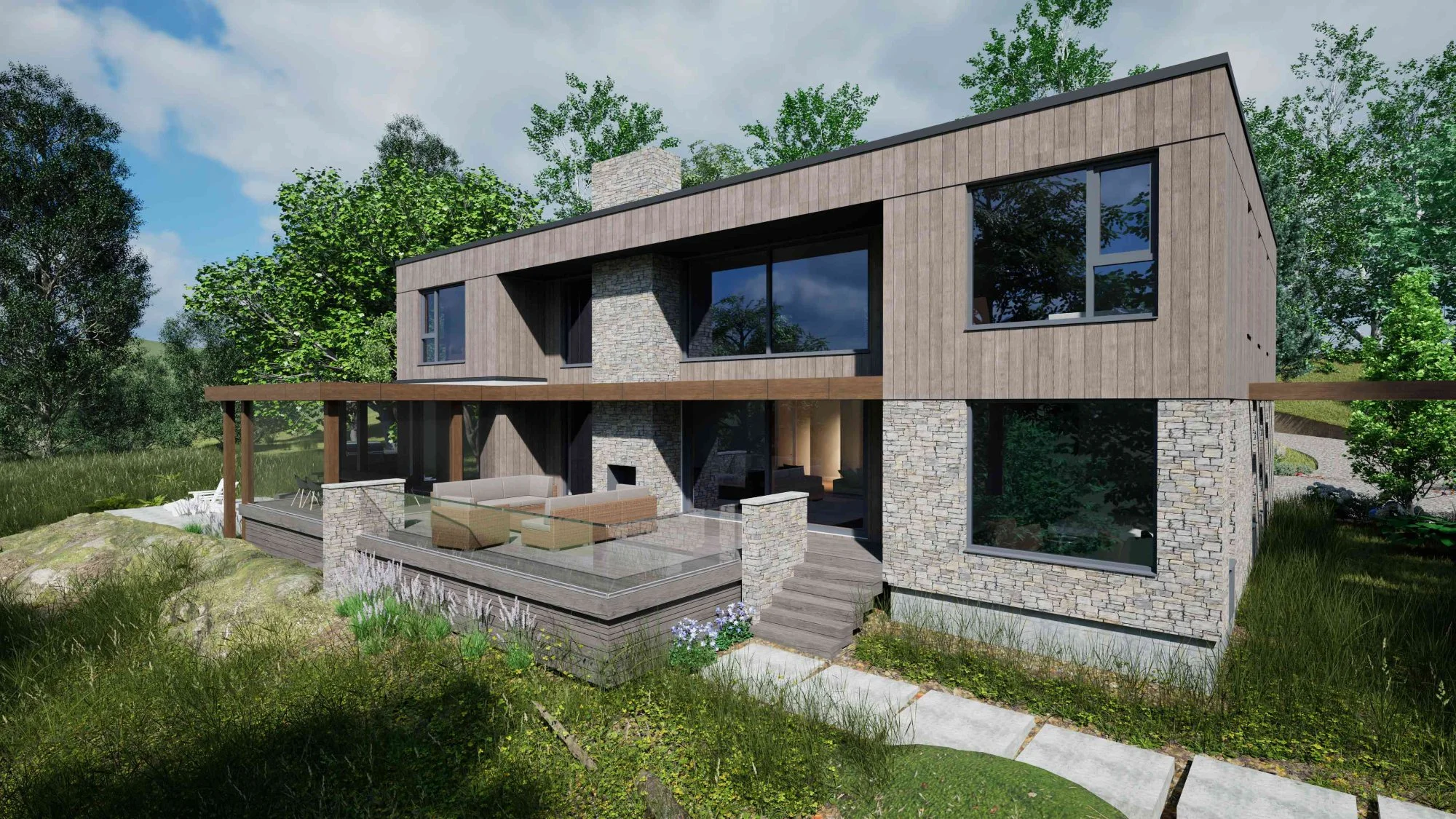 Modern two-story house with large windows, stone and wood exterior, outdoor seating area on a deck, surrounded by greenery and trees under a cloudy sky.