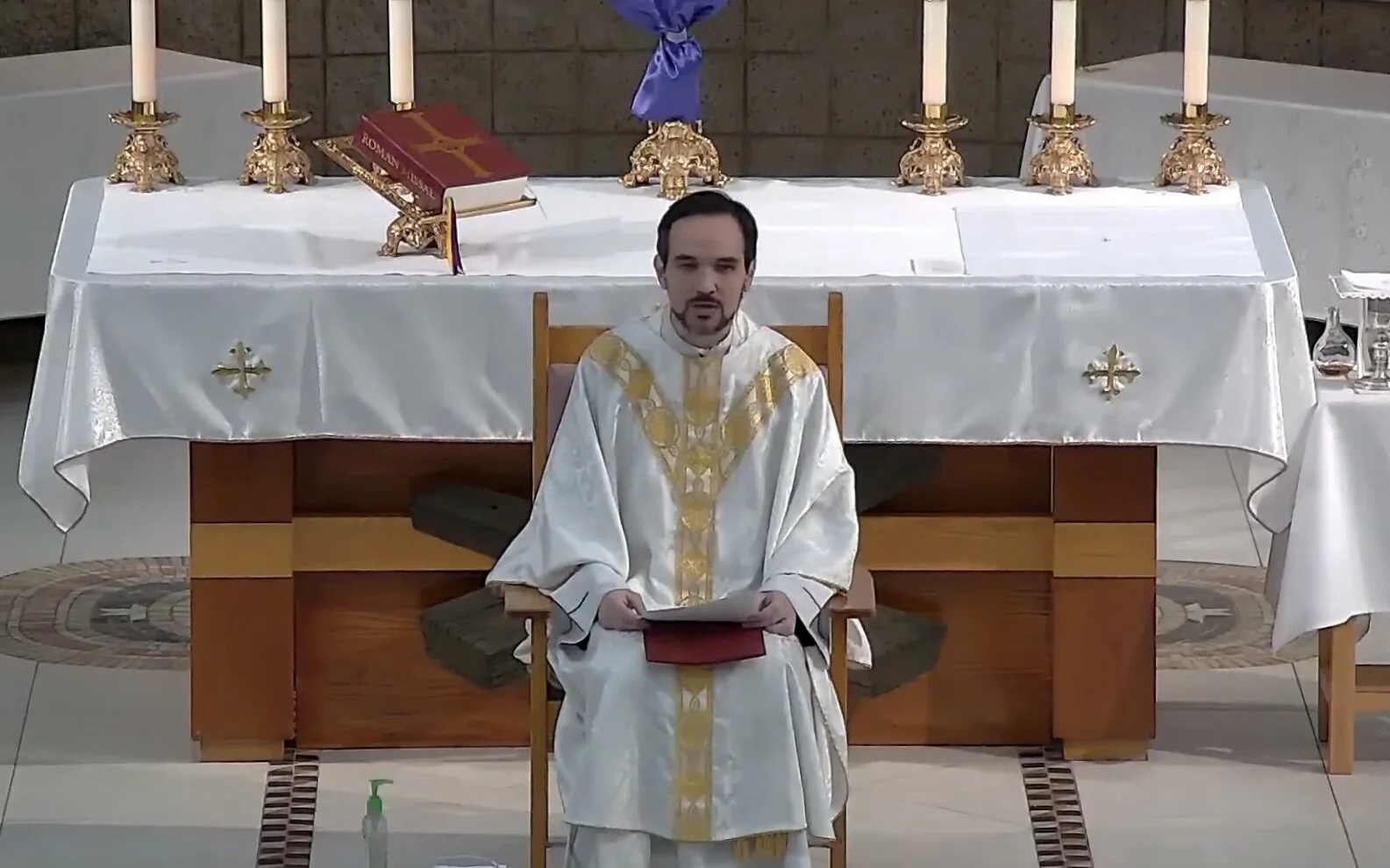 A priest begs forgiveness for withholding the Eucharist:  "We abandoned you." 