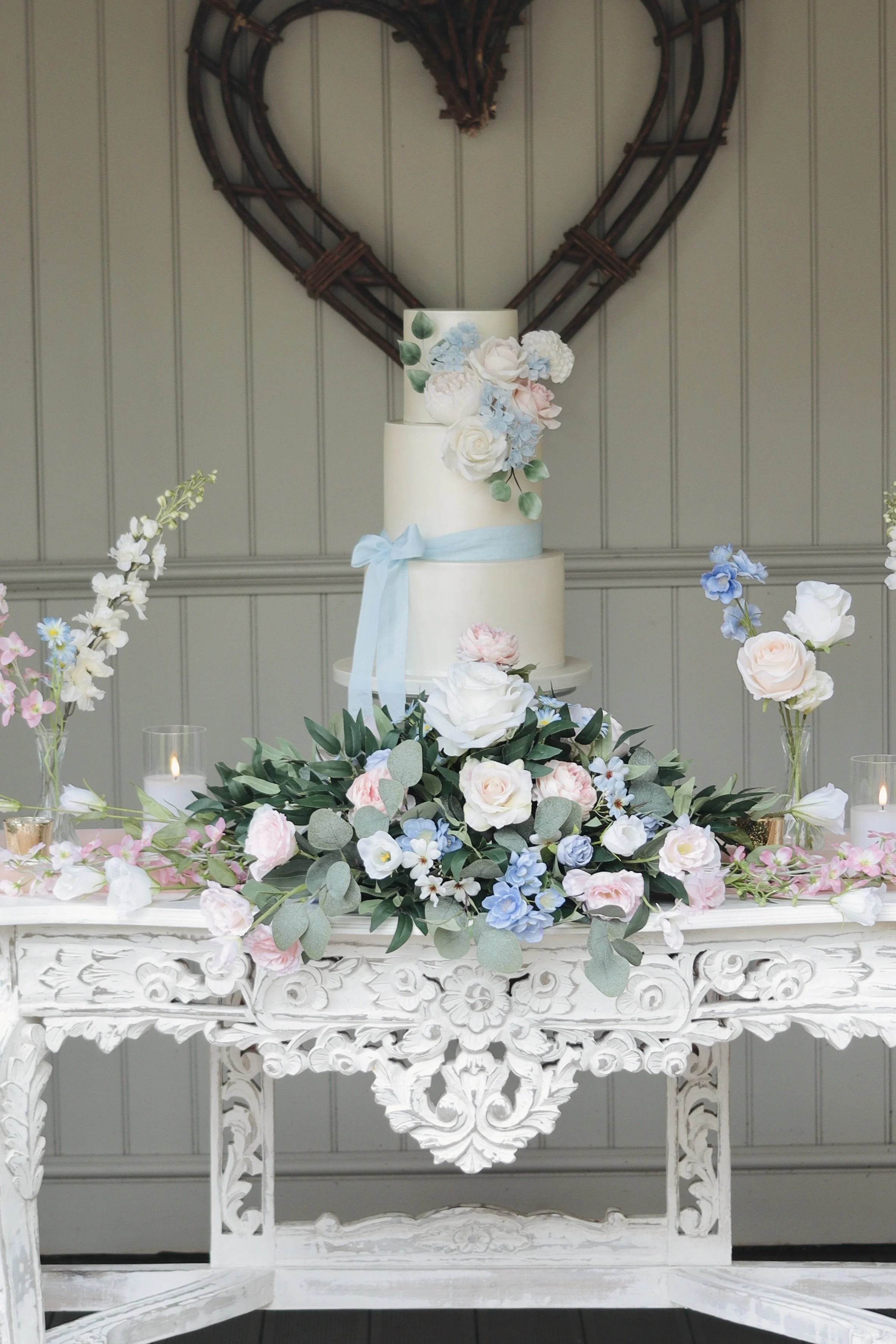3 tier satin white wedding cake with blush pink and blue sugar flowers.JPG
