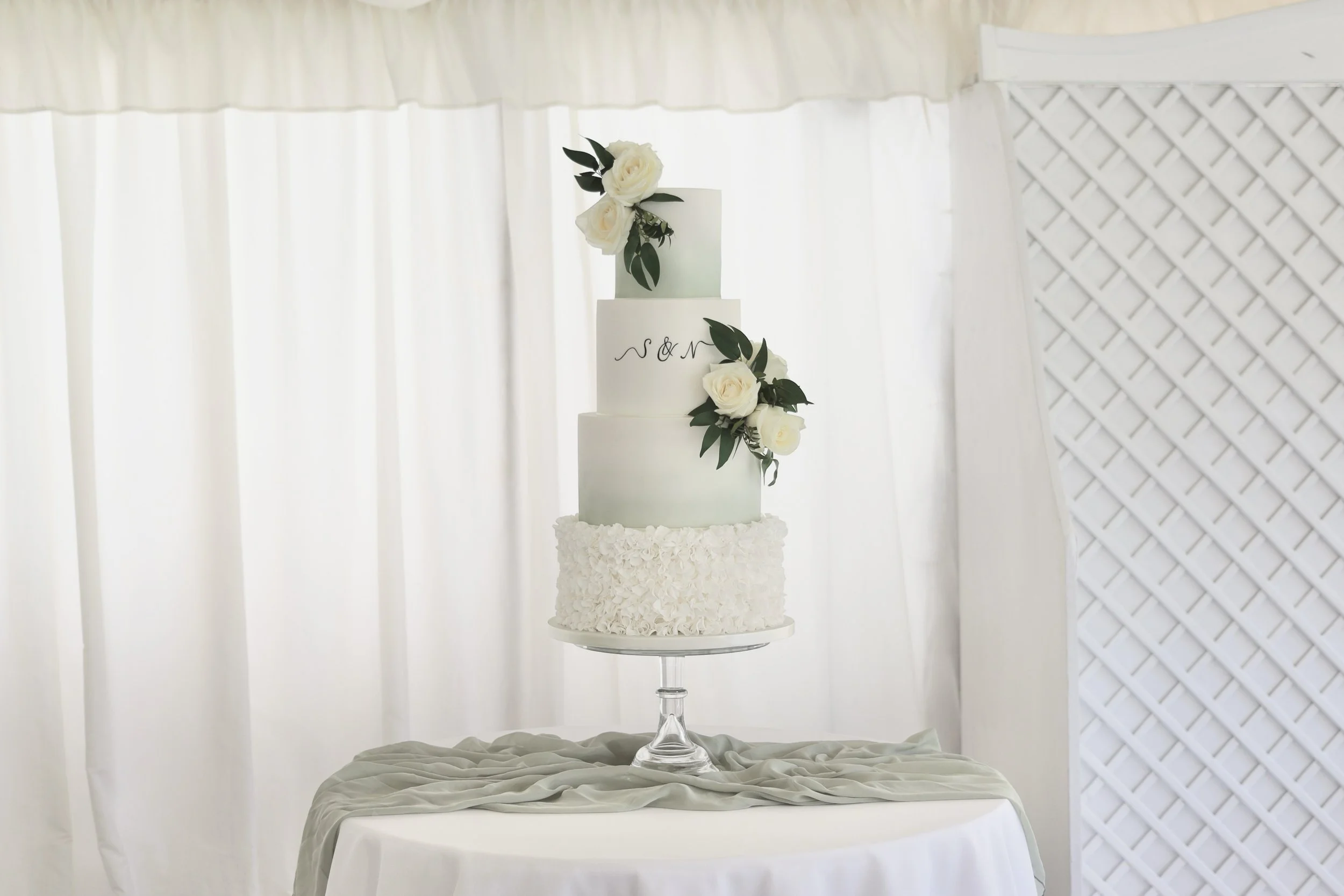 4 tier age green ombré wedding cake with ruffles and flowers.JPG