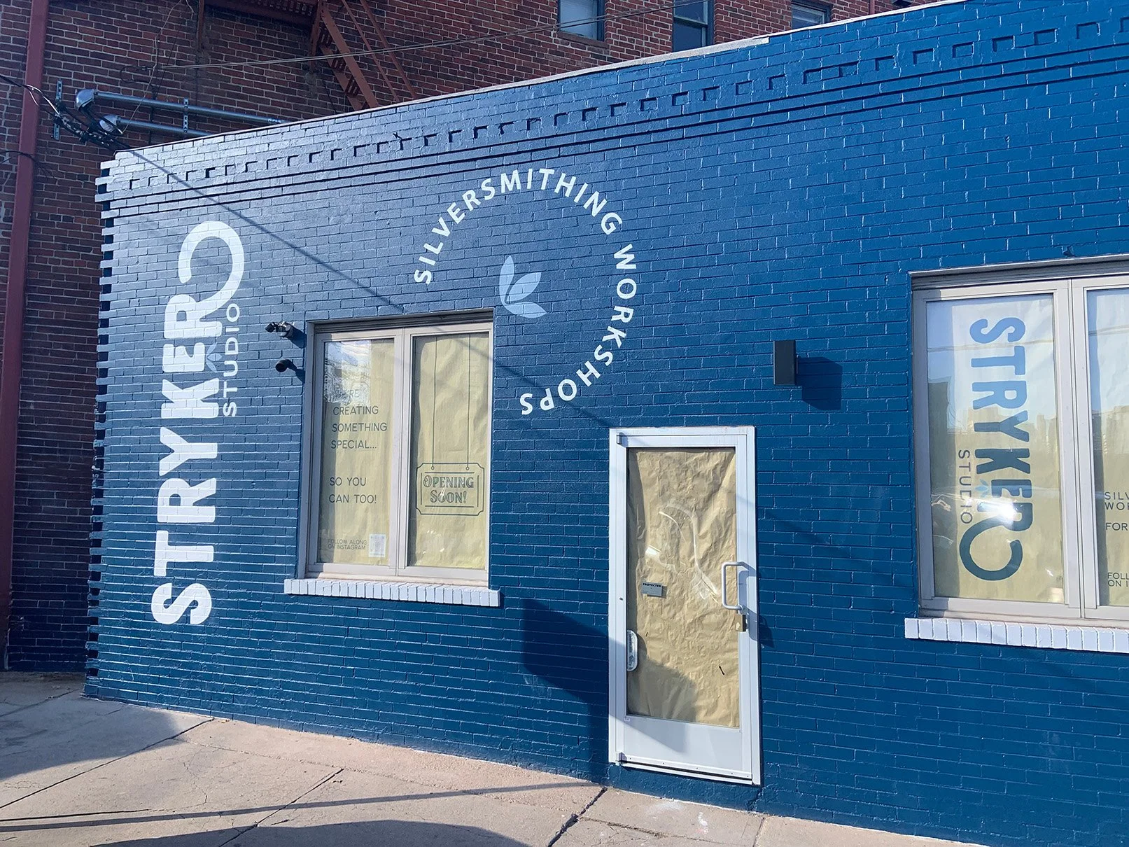 Stryker Studio Denver Colorado silversmithing studio hand painted exterior sign
