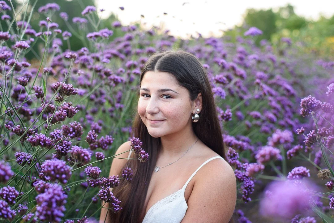 image is of a senior girl in a field of purple flowers