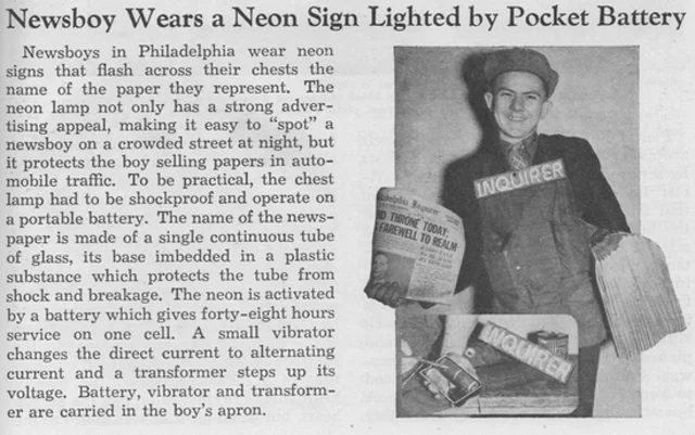 A newsboy from Philadelphia wears a neon sign to sell his papers in 1937 (Novak Archive)