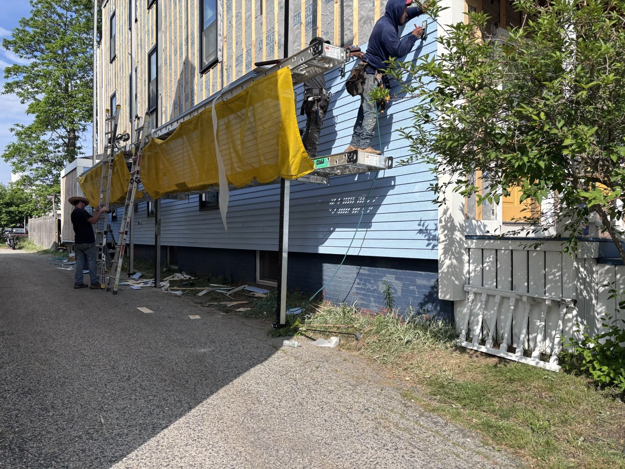 03 · Installing the blue LP SmartSide siding.