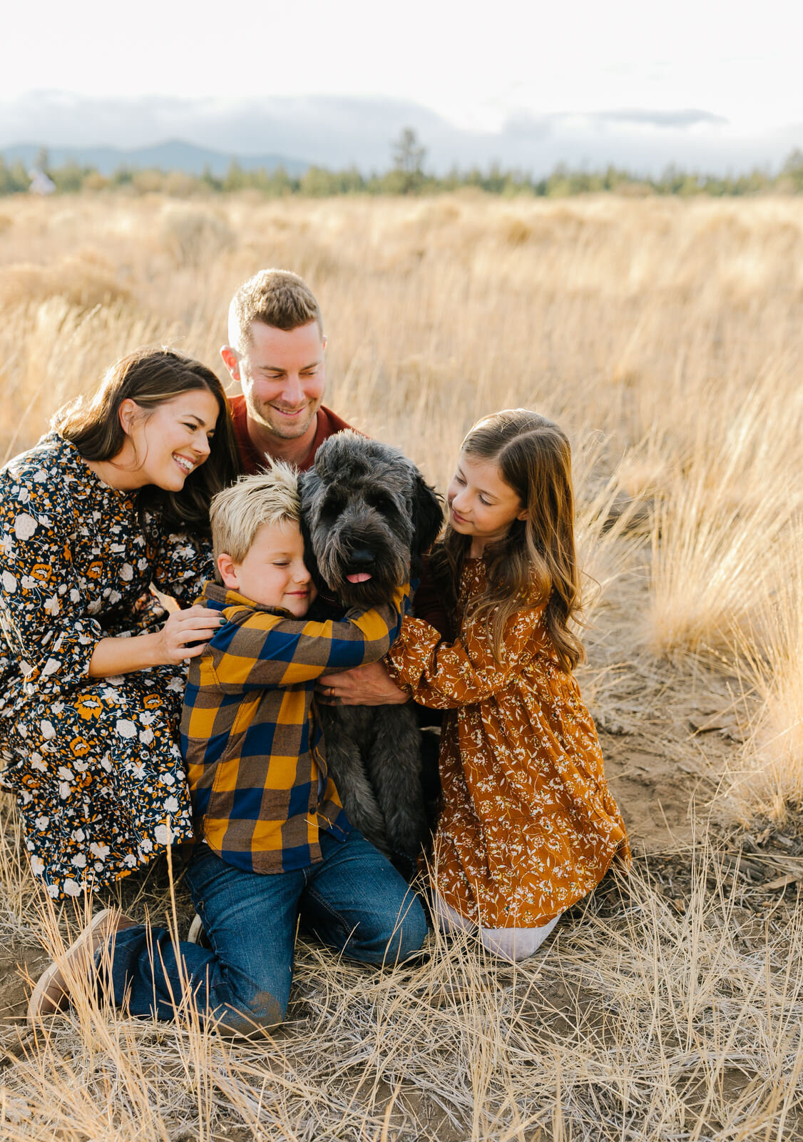 Bend Family Photographer- Shevlin Park-Family of four with dog poses