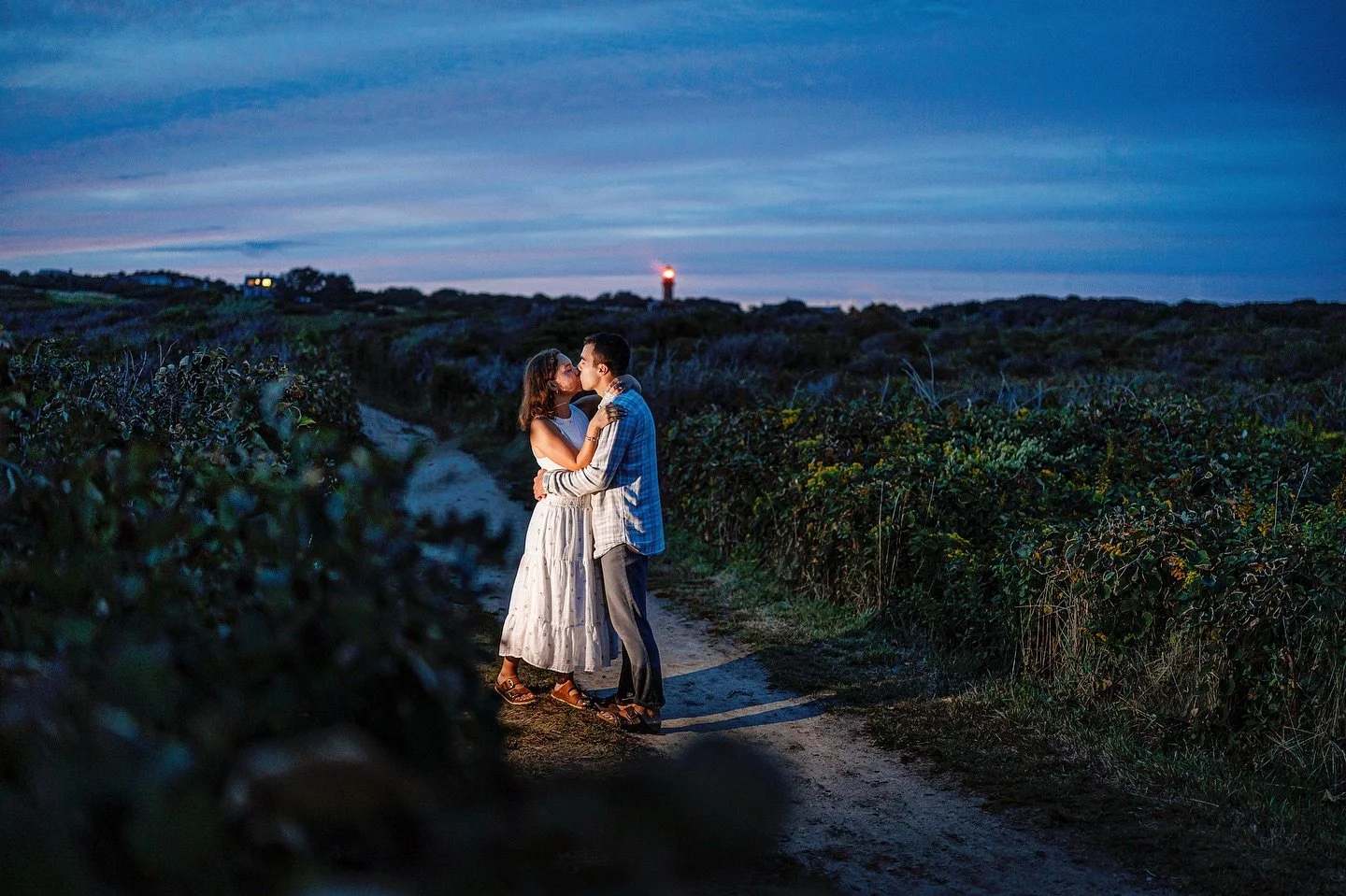On the walk back in near darkness from a wonderful sunset engagement shoot at Moshup beach, I asked them to humor me and let me hide my phone flashlight in a bush and make them hold the kiss until the lighthouse light hit the right angle. The best li