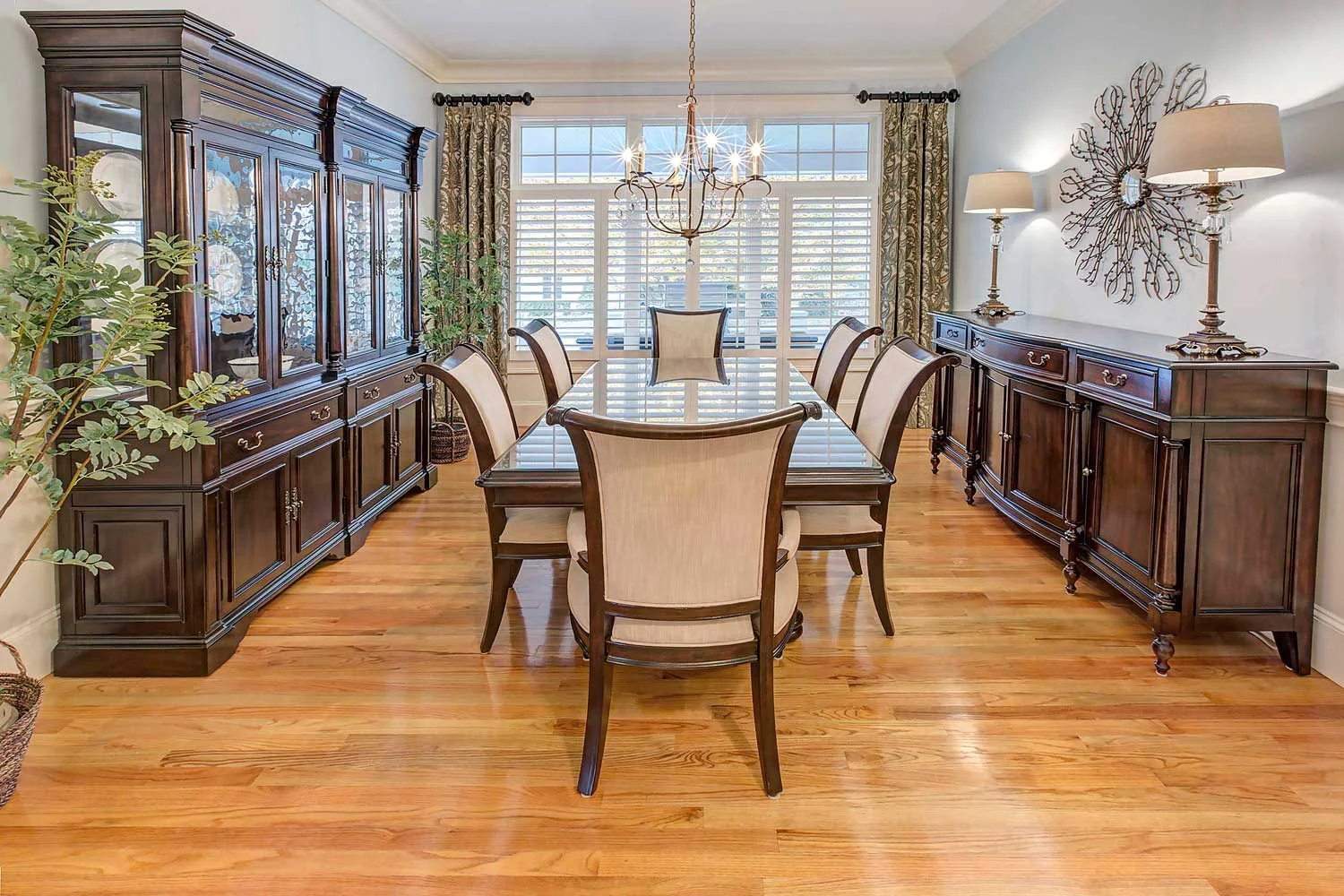 The Hooker Furniture dining table has an inlaid star and the china cabinet has seeded glass.