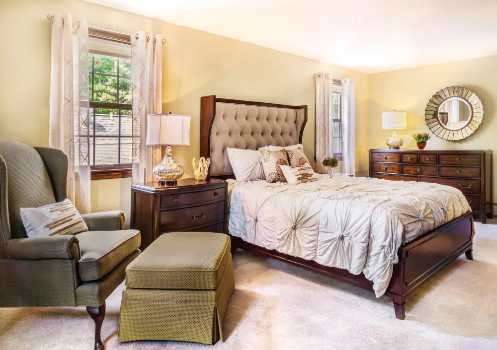 The bedroom has a linen upholstered shelter bed, bachelor chest, 3 drawer nightstand and dresser.