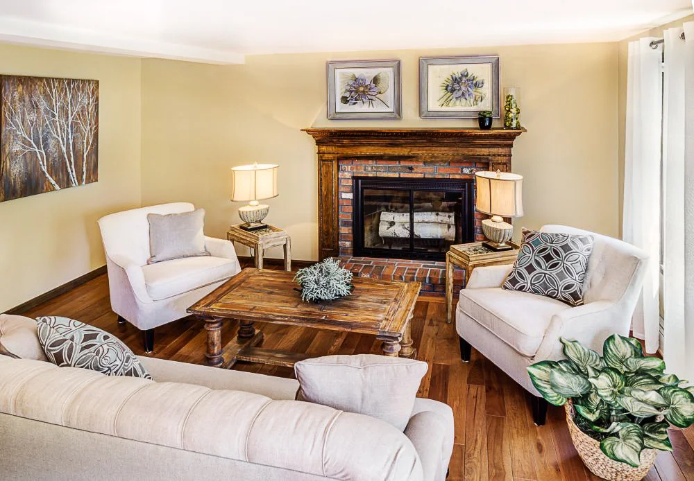 The living room contains a button tufted taupe linen upholstered sofa with espresso leg finish.