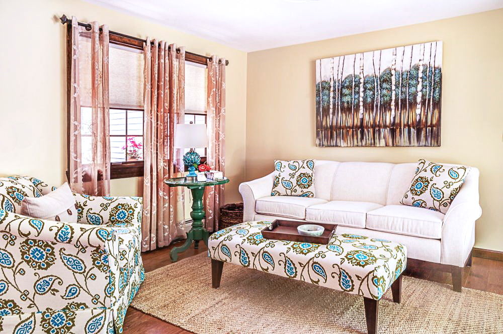 A light linen sofa was paired with a comfortable club chair in mojito fabric of teals and greens.