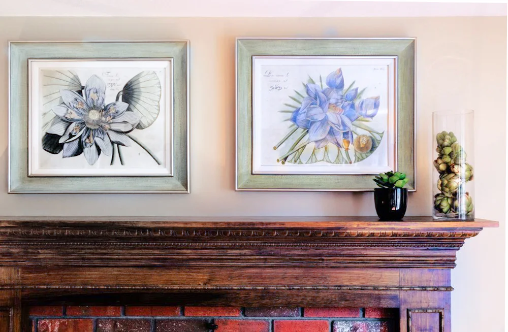 Blue lotus linen matted pictures were placed above the fireplace.