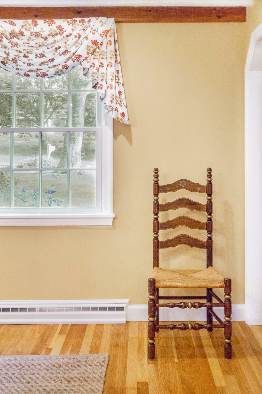 A seagrass textured area rug and custom linen fabric swag.