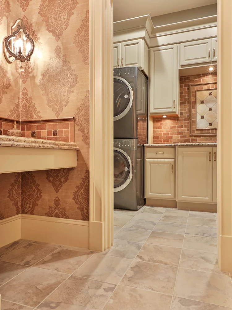 The bathroom is located just off the laundry room.