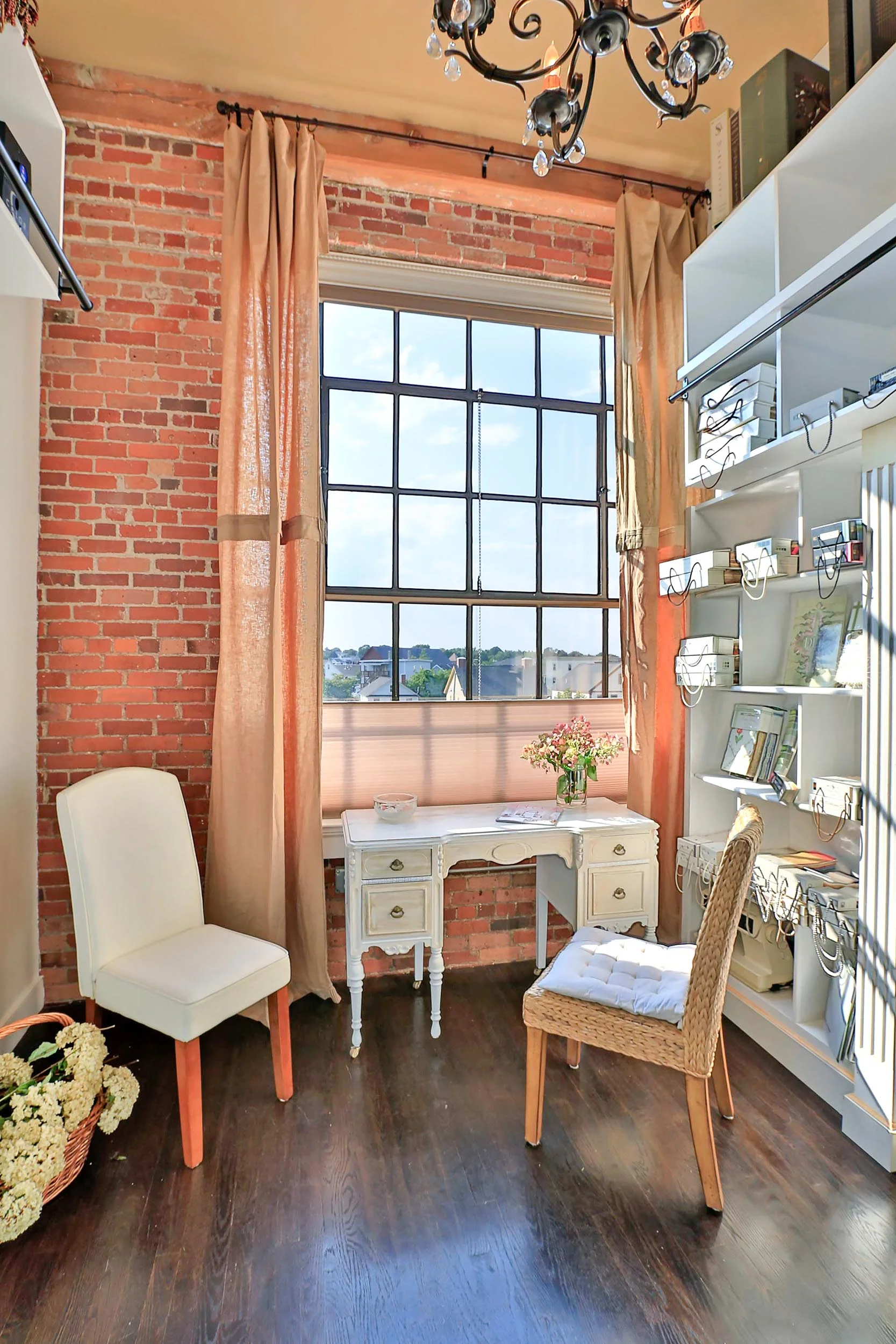 The open concept design has exposed brick, hardwood floors with a walnut finish.