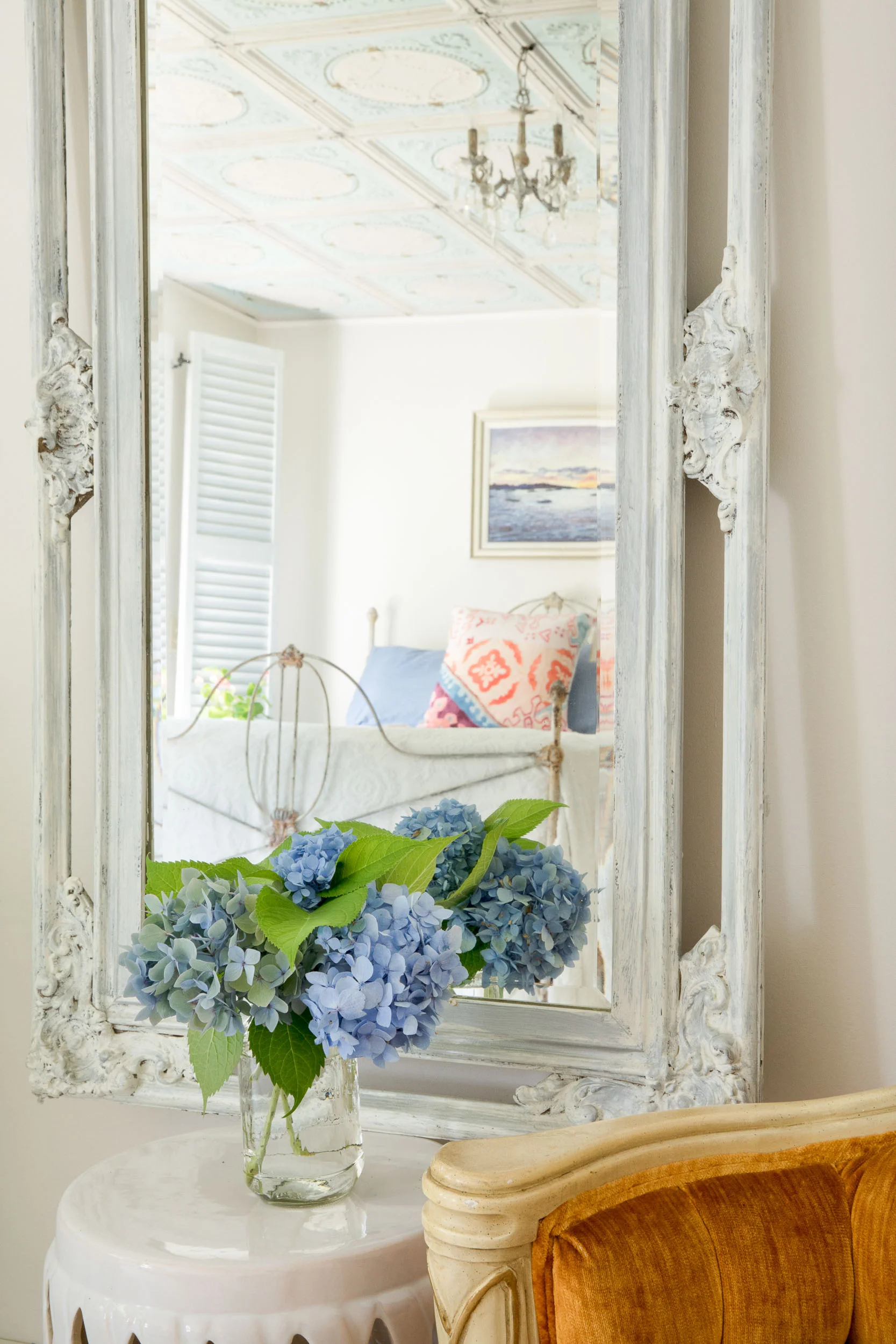 A rusted iron side table, another vintage find was painted in off-white