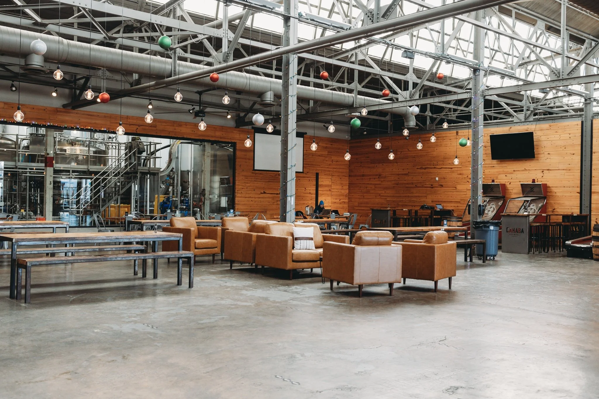 Reception set-up inside Cahaba Brewing Company in Birmingham, Alabama with industrial architecture and catering by Tre Luna Catering.