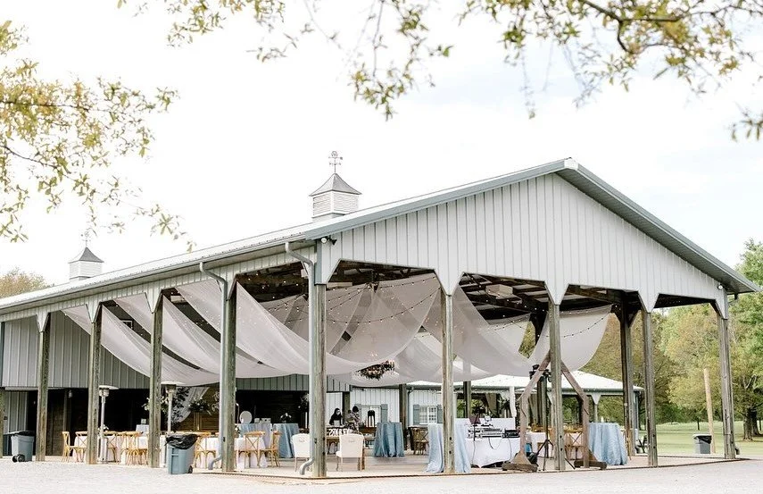 Rustic barn and covered pavilion at The Barn at Twin Valley wedding venue in Prattville, Alabama.