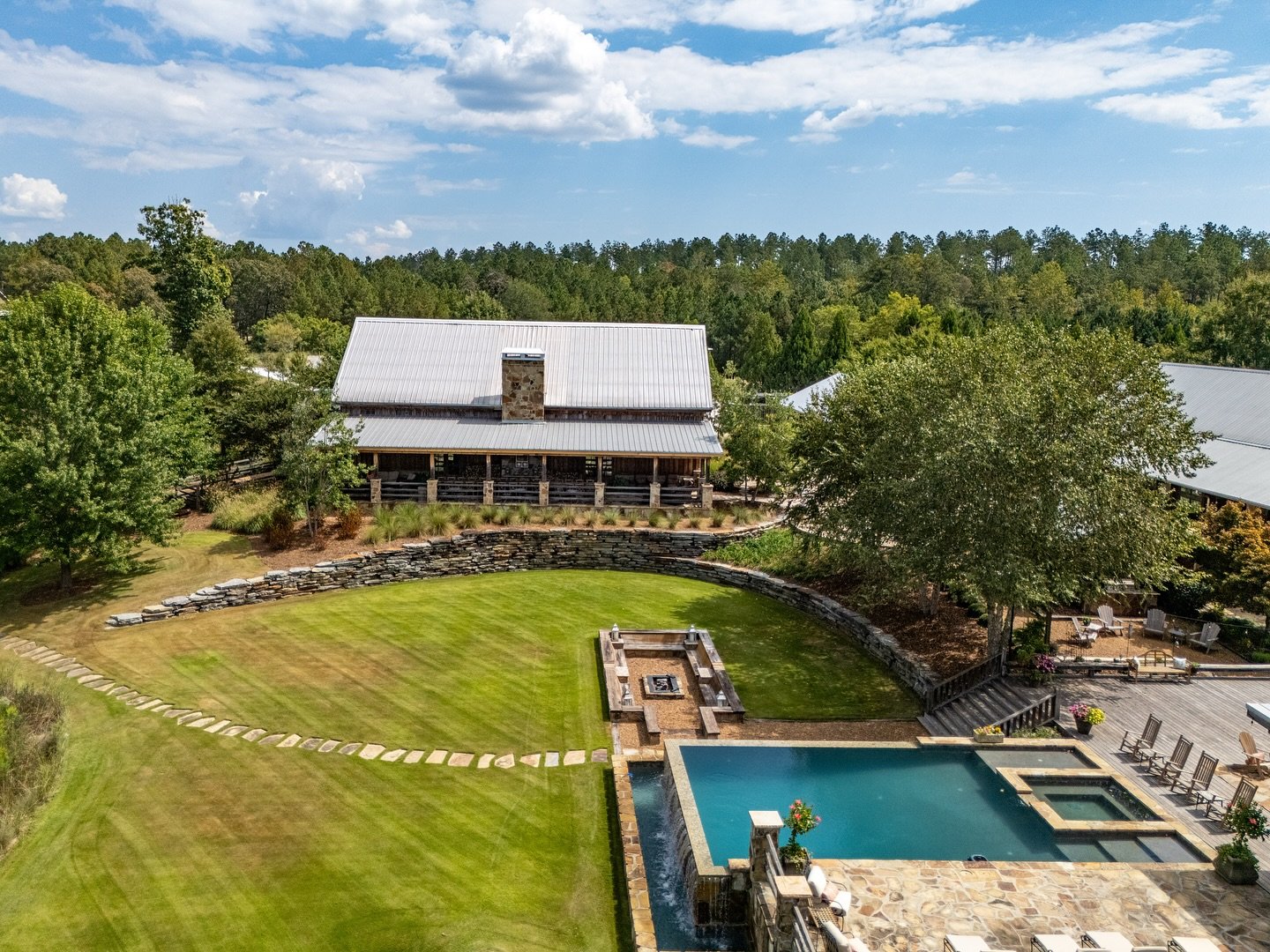 Otter Creek Farmstead barn overlooking rolling countryside, pool, and gathering space near Birmingham, Alabama