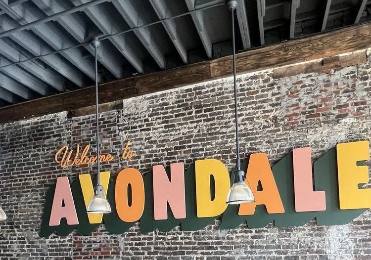 Avondale Brewing Company event venue in Birmingham Alabama featuring industrial interior space and outdoor courtyard with stage.