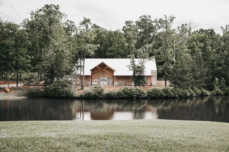 Outdoor ceremony and reception space at Belle Farm wedding venue in Alabama featuring open pastures, white fencing, and scenic countryside views.