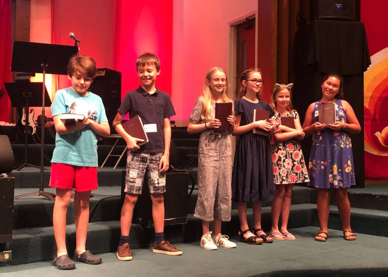 Fifth graders getting Bibles during the church service, 2019